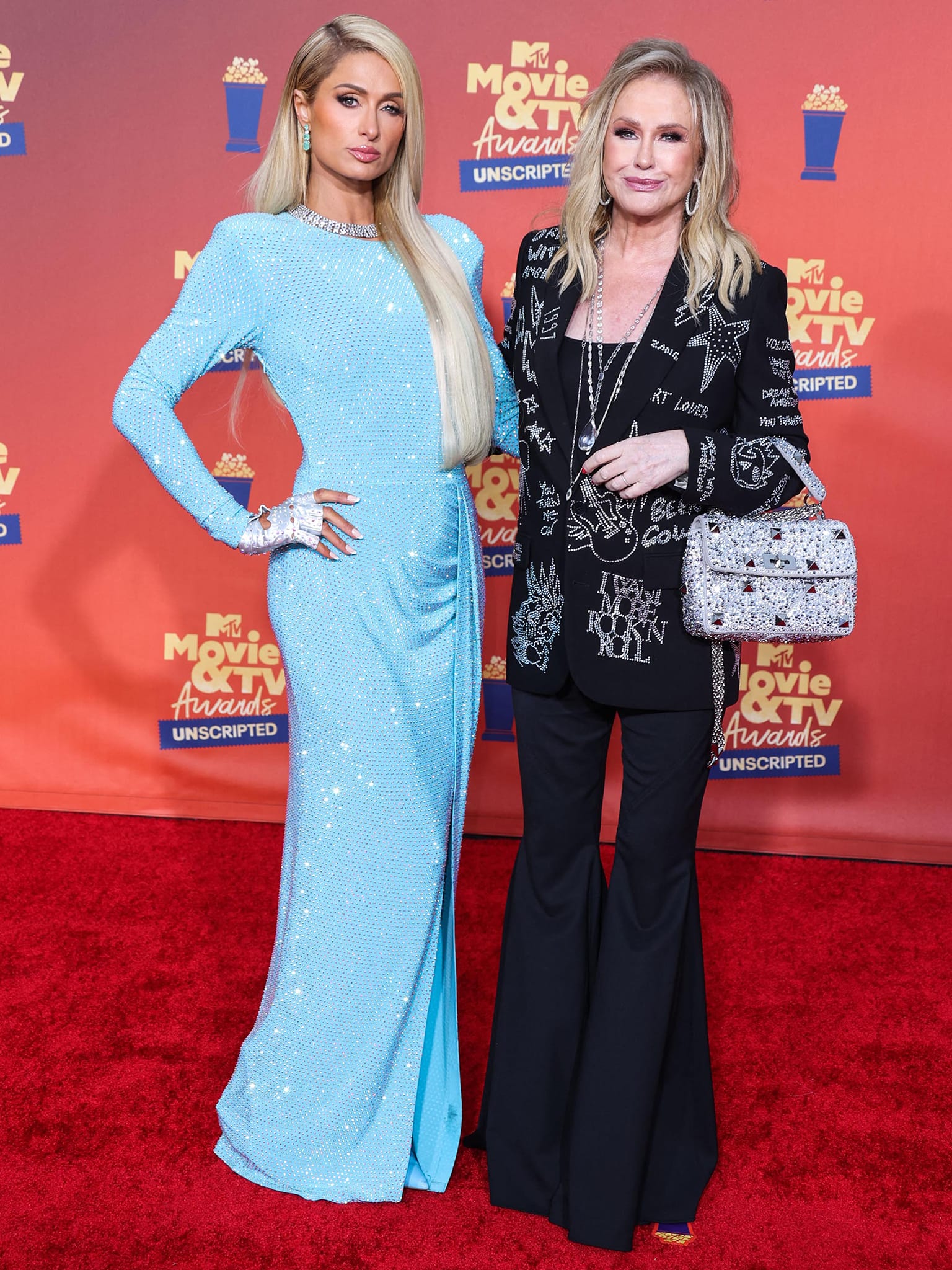 Kathy Hilton joins her daughter Paris on the red carpet wearing an edgy Zadig + Voltaire bejeweled blazer with bell bottoms