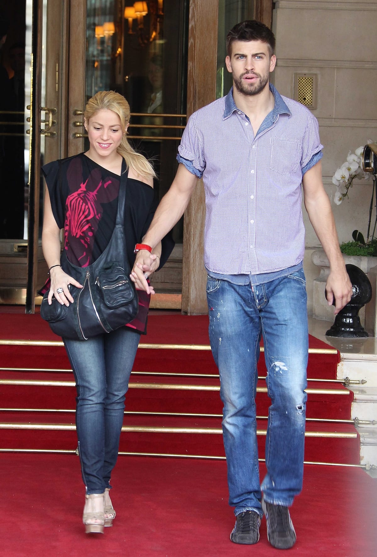 Shakira, in wedge sandals and skinny jeans, still appears much shorter than 6ft 4 Gerard Piqué as the couple step out in casual coordinated denim looks