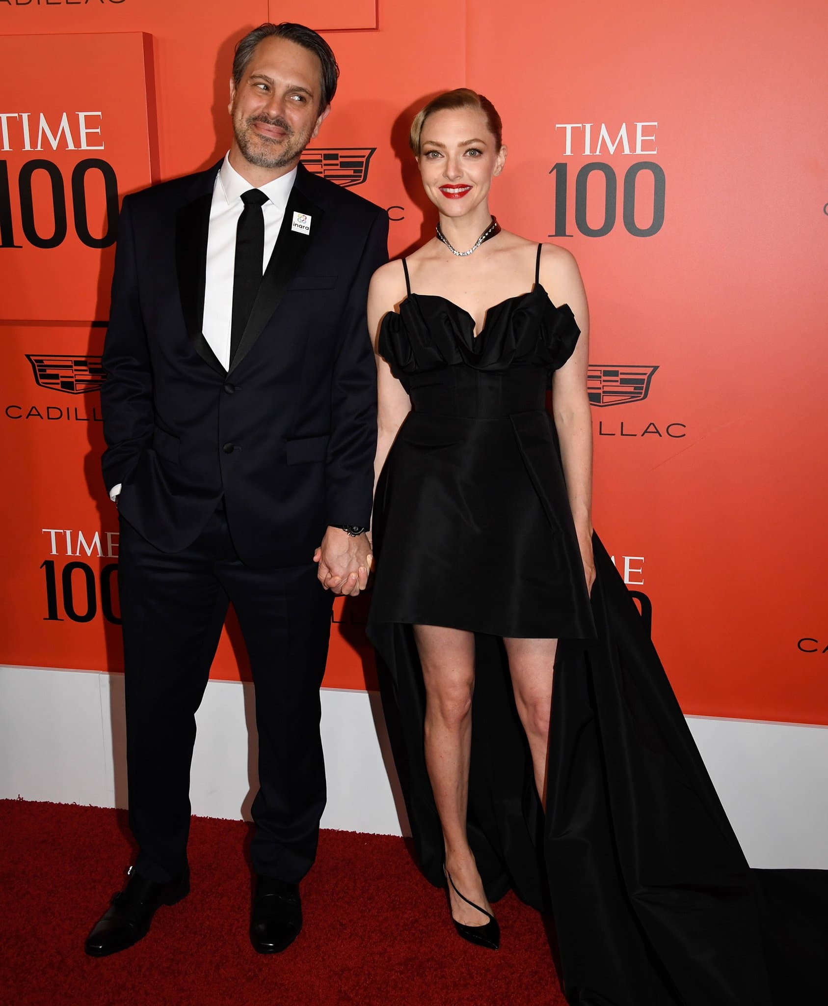 Thomas Sadoski joins Amanda Seyfried at the TIME 100 Gala in a sharp black suit and dress shoes, finishing the classic look with an INARA pin that reflects the couple’s shared advocacy