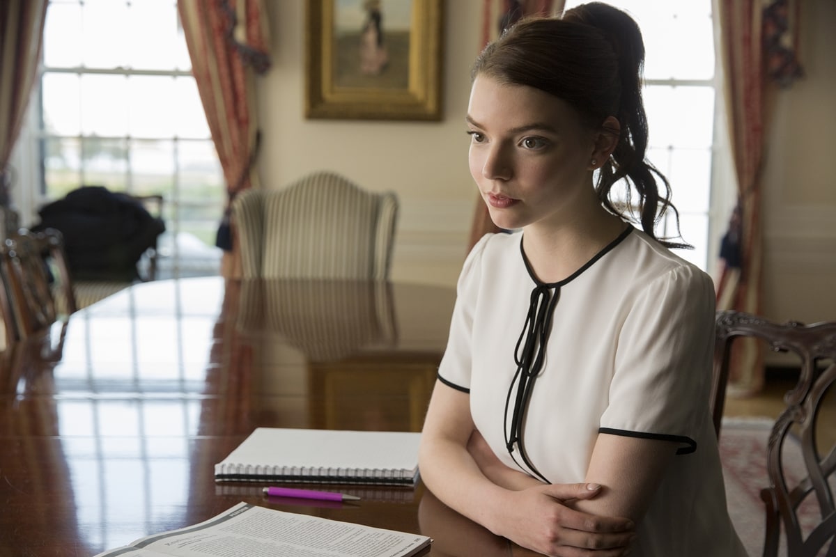 Anya Taylor-Joy as Lily Reynolds in Thoroughbreds (2017), wearing a crisp ivory blouse with black piping and a ribbon tie—perfectly reflecting her character’s polished exterior and underlying tension