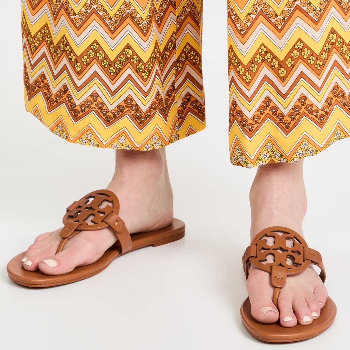 Crafted in full-grain leather, these Tory Burch Miller sandals feature the original laser-cut logo and hand-painted edges