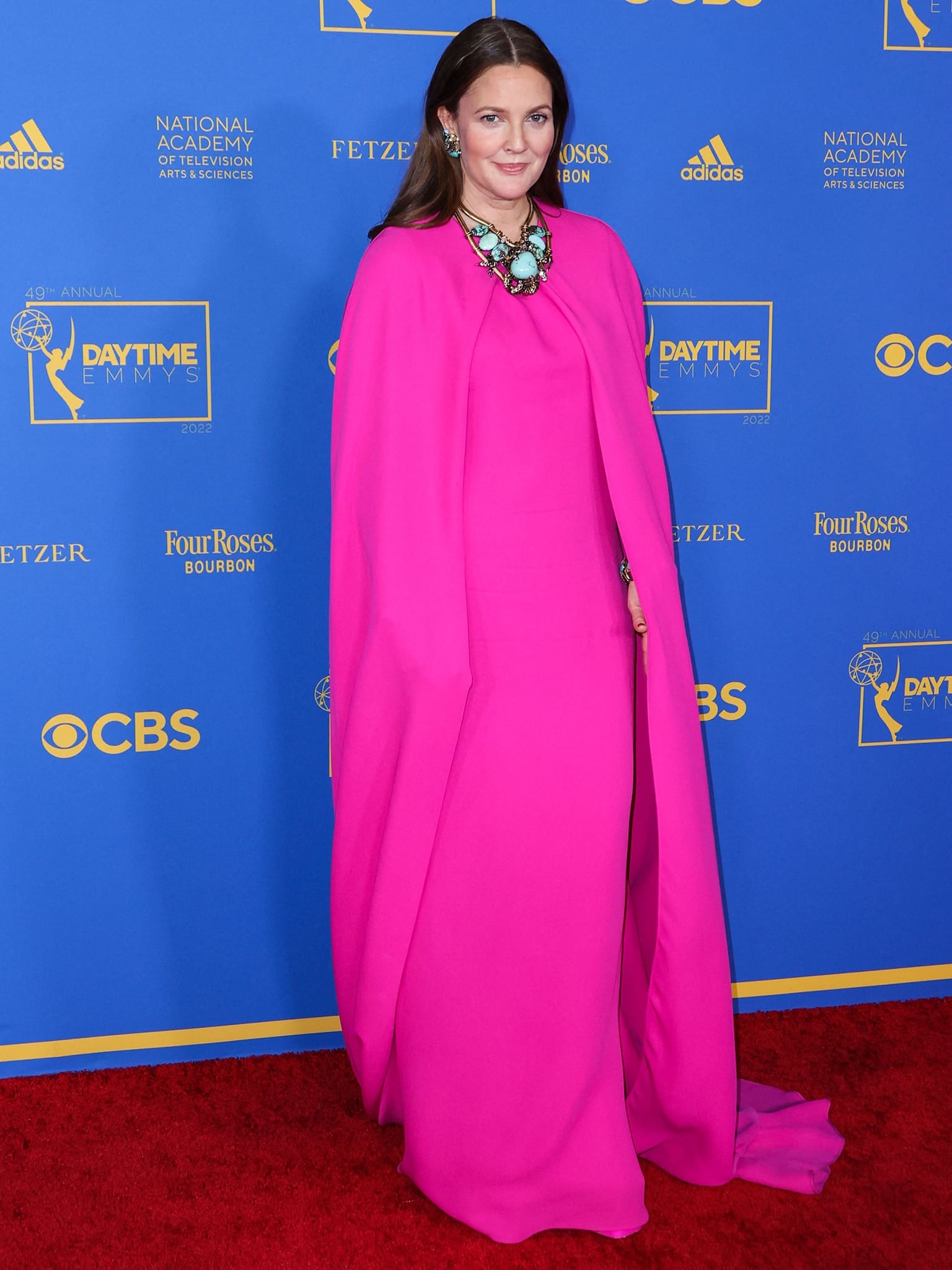 Drew Barrymore commands the red carpet in a custom Valentino PP Pink cape gown at the 49th Annual Daytime Emmy Awards in Pasadena