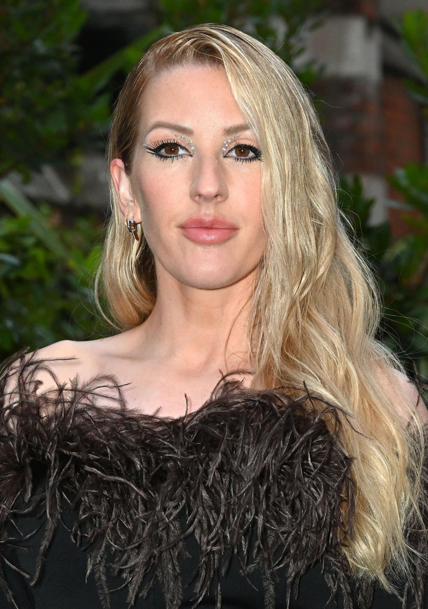 Ellie Goulding opts for a dramatic makeup look, with crystal-lined lids and winged liner