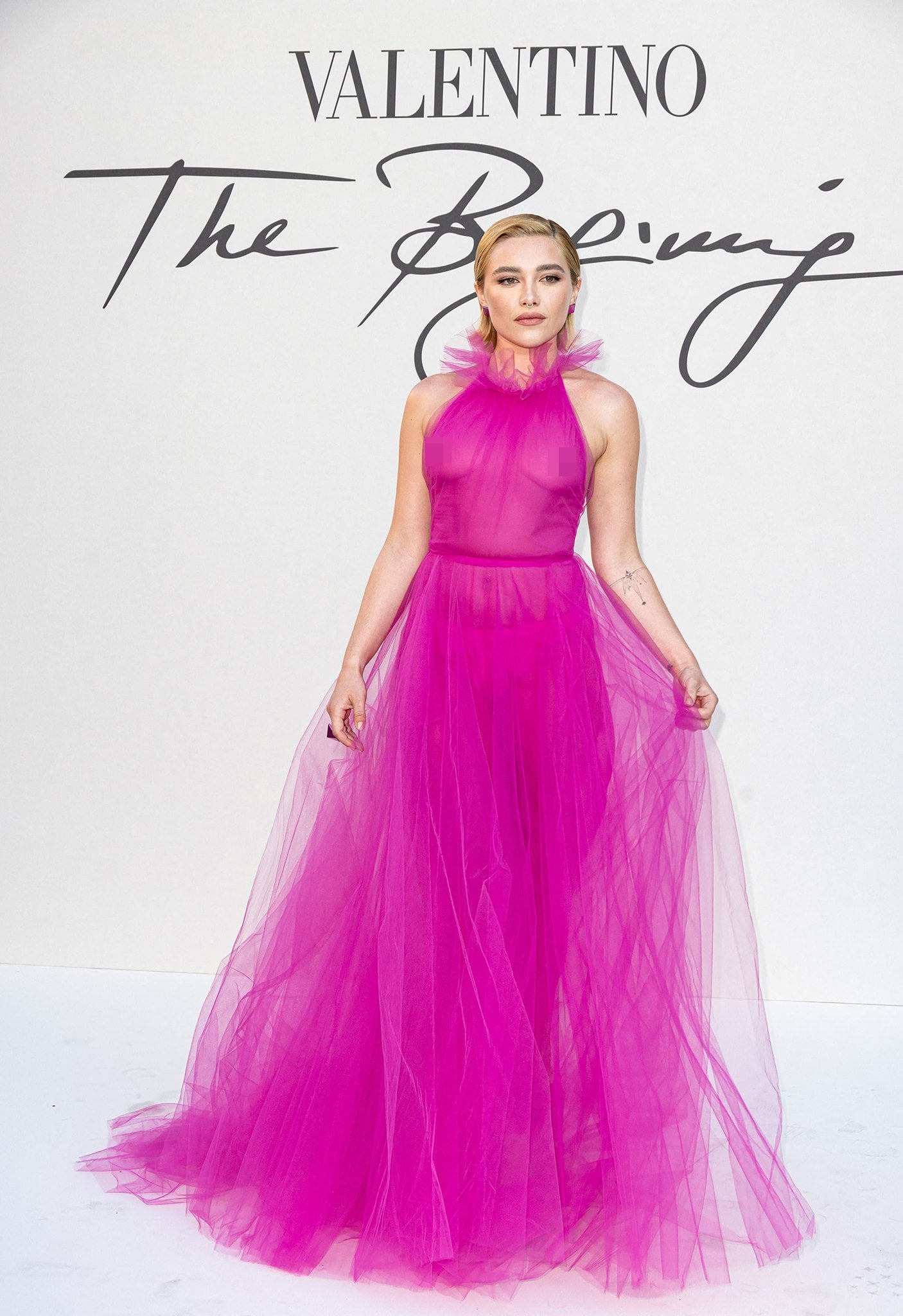 Florence Pugh made a bold Valentino statement in a sheer Pink PP tulle gown, finishing the look with matching Valentino Tan-Go platform pumps that amplified the drama of her couture moment