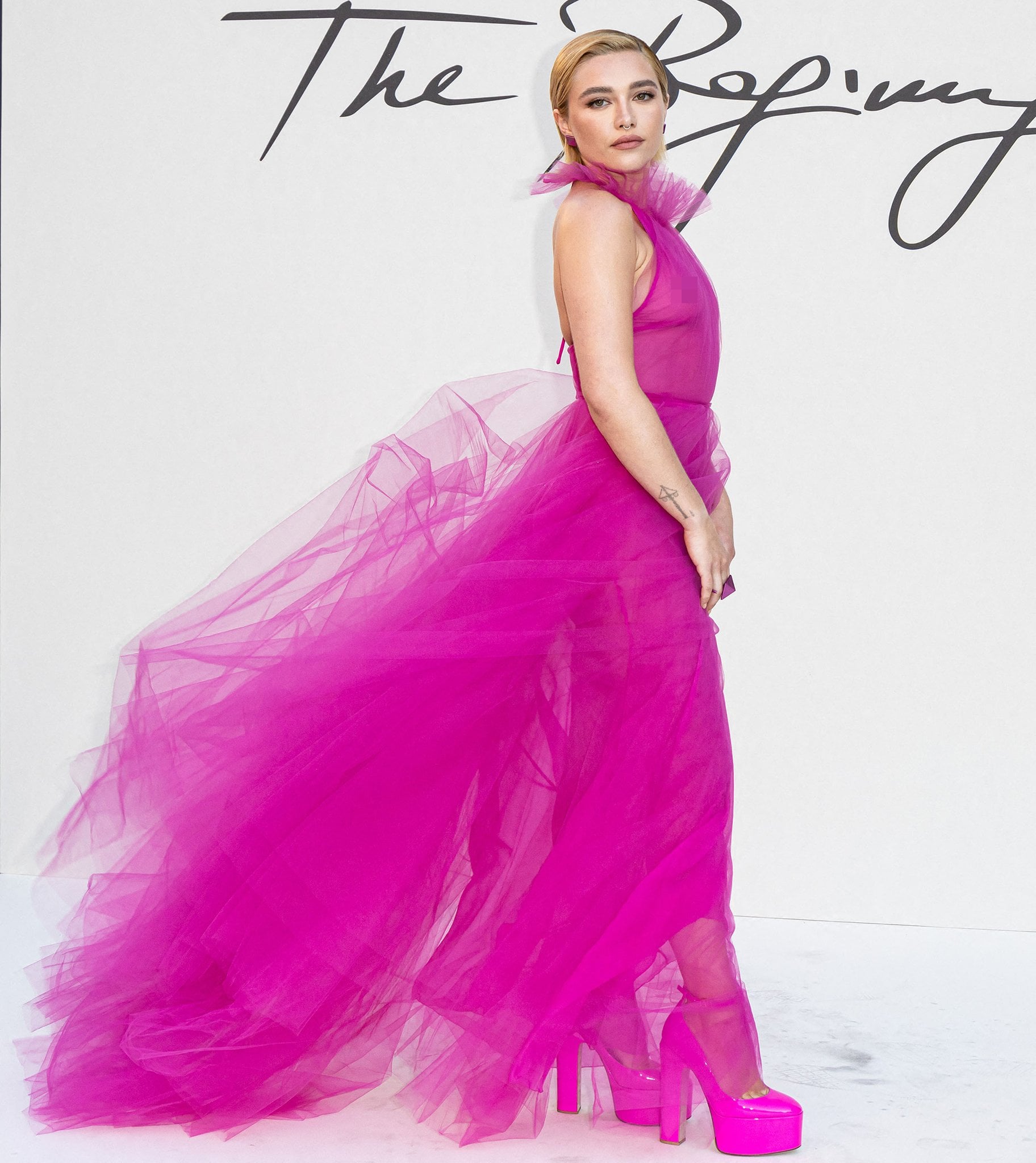 Florence Pugh let her sheer Pink PP Valentino gown billow dramatically behind her, pairing it with matching Tan-Go platform pumps that grounded the ethereal look with bold, sky-high structure