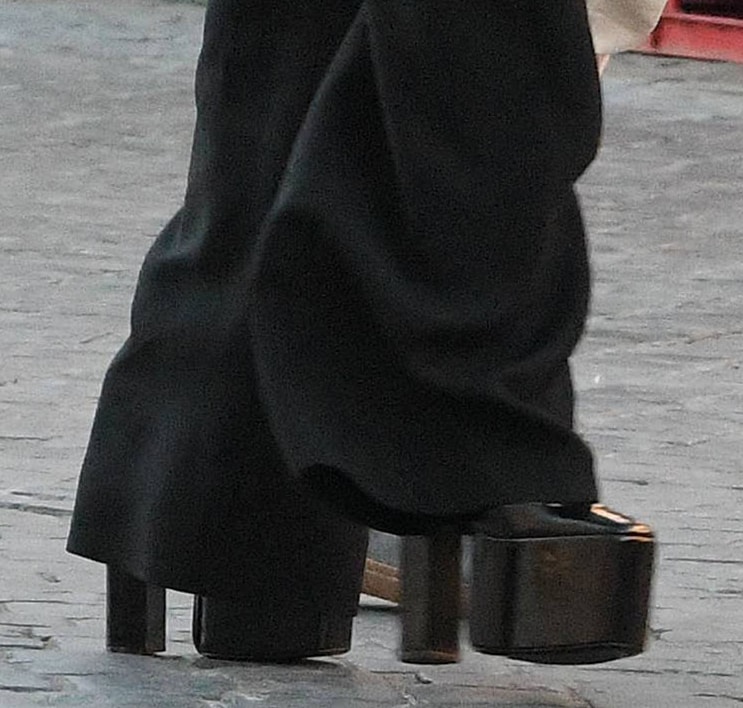 Kate Hudson steps out in Valentino’s ultra-high black Tan-Go platform pumps, partly concealed beneath her flowing trousers