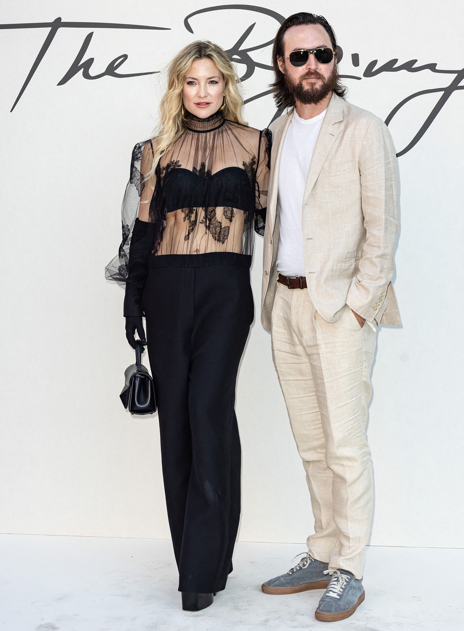 The actress poses with fiancé Danny Fujikawa, pairing her sheer lace Valentino ensemble with wide-leg pants for an elegant contrast to his linen suit