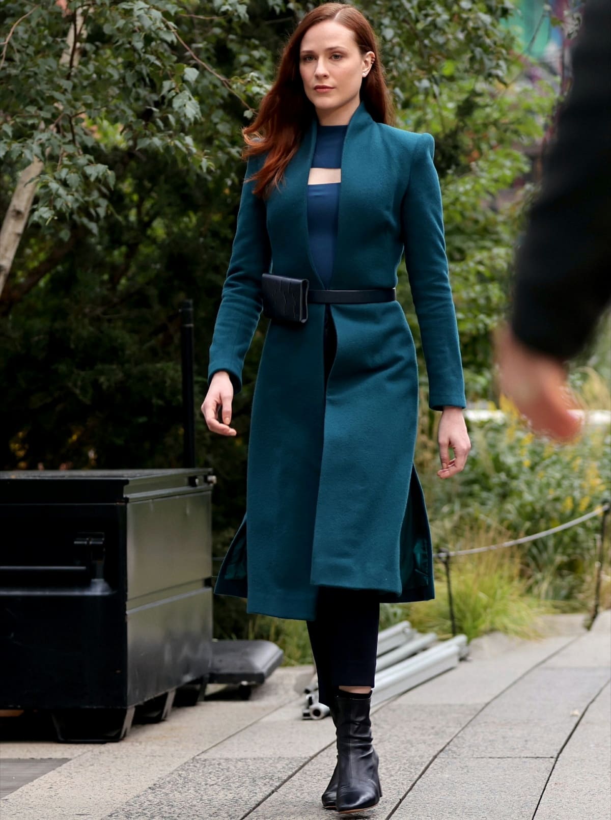 Evan Rachel Wood, filming Westworld in Manhattan, New York, on October 5, 2021, stuns in a structured teal coat, sleek belt bag, and black leather ankle boots