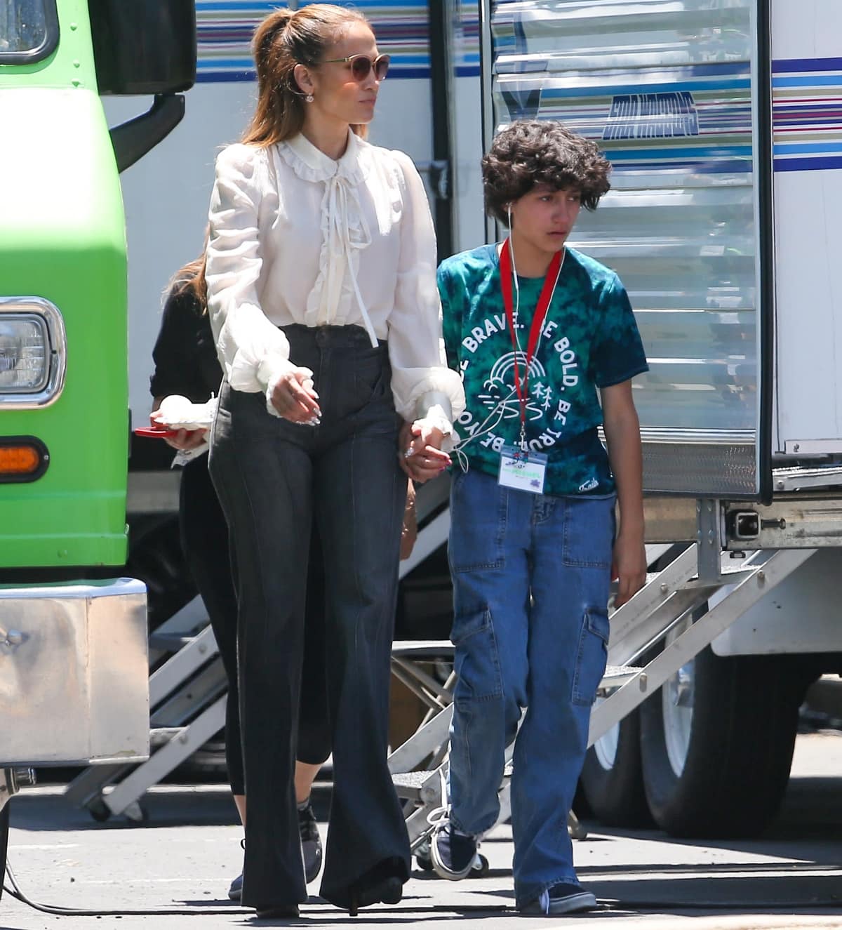 Jennifer Lopez paired a romantic white blouse with dramatic flared trousers while spending time with Emme in Los Angeles, adding her usual polished edge with oversized sunglasses and towering heels