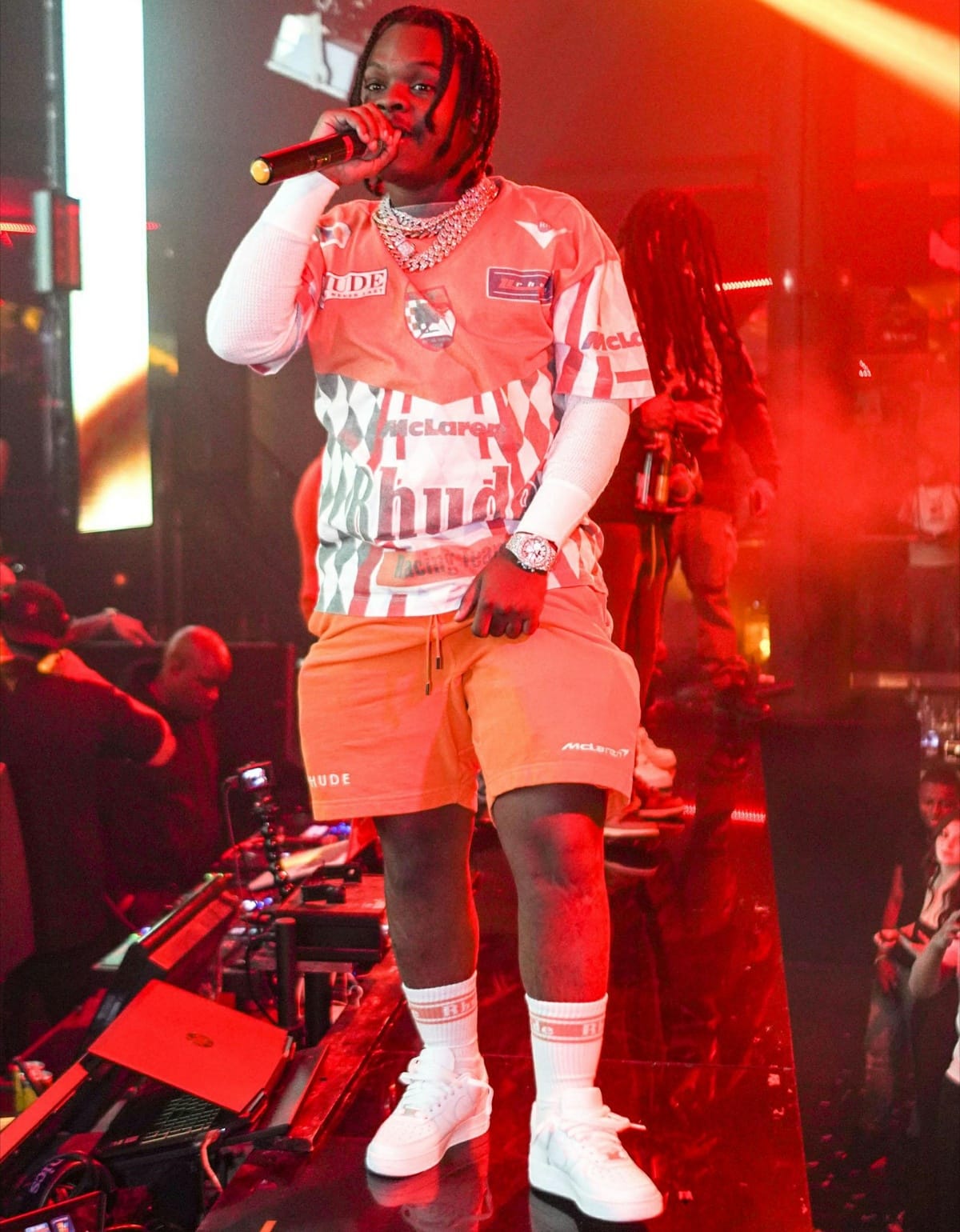 42 Dugg rocks white low-top sneakers with matching Rhude socks and a McLaren x Rhude racing set while performing on stage at Story nightclub in Miami on November 26, 2021
