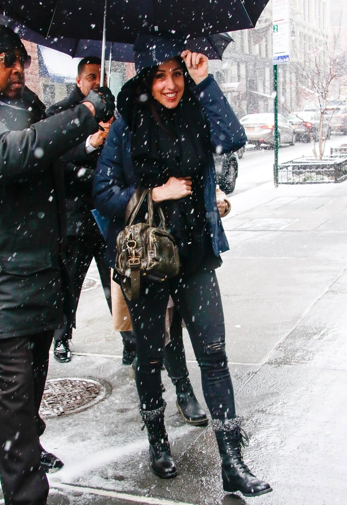 Catherine Reitman stays stylish in the snow, pairing edgy lace-up combat boots with ripped black jeans and a cozy puffer jacket outside the Build Studio in New York City on February 20, 2019