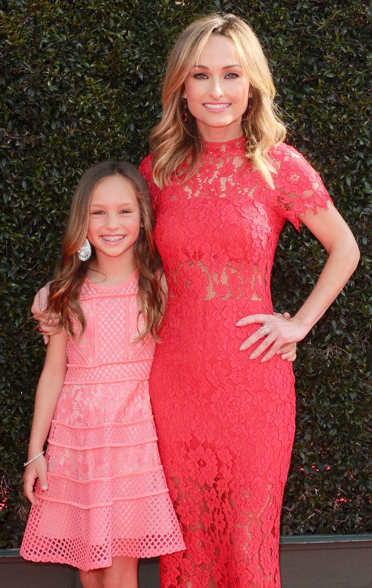 Giada De Laurentiis and daughter Jade coordinate in vibrant lace looks at the 2018 Daytime Emmy Awards, with Giada in a stunning form-fitting red gown and Jade in a flared pastel pink dress with tiered mesh detailing