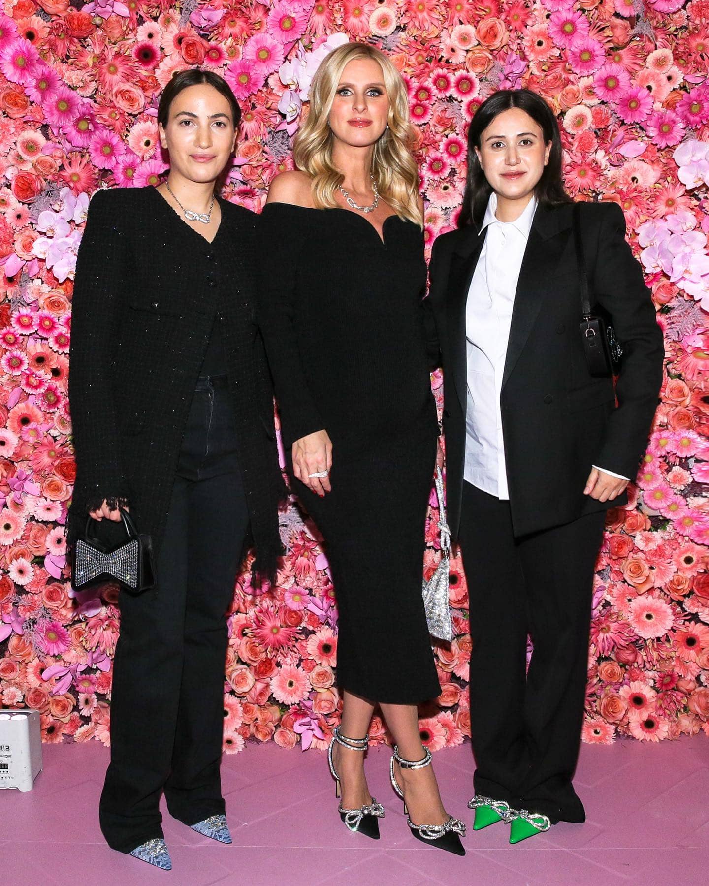 Sisters Nina and Gvantsa Macharashvili, founders of the Georgian footwear label Mach Mach, pose with Nicky Hilton at an event celebrating their crystal-embellished designs