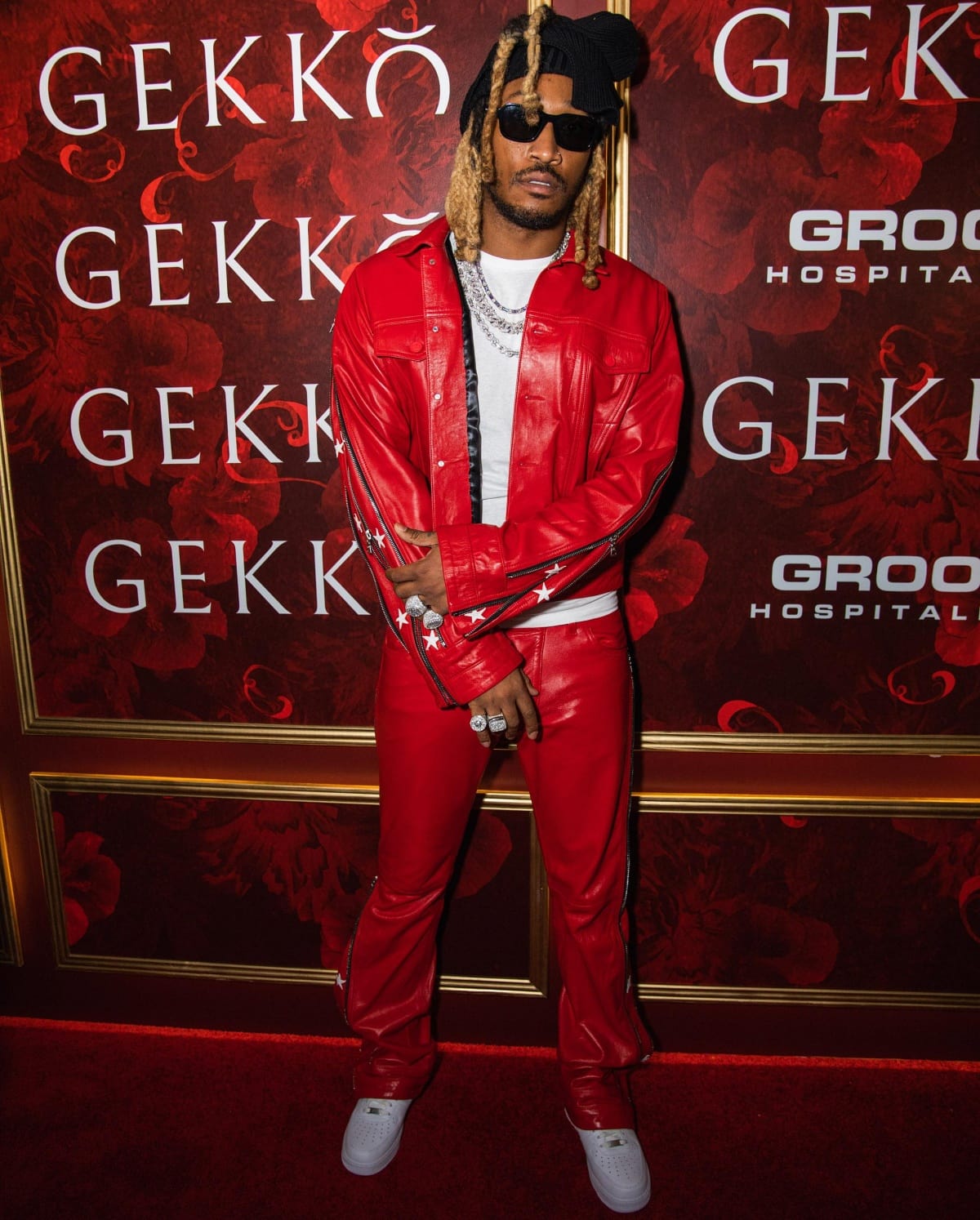 Future makes a bold statement in a red leather outfit with star details, blending in with the lavish décor at the Gekkō grand opening in Miami on August 10, 2022