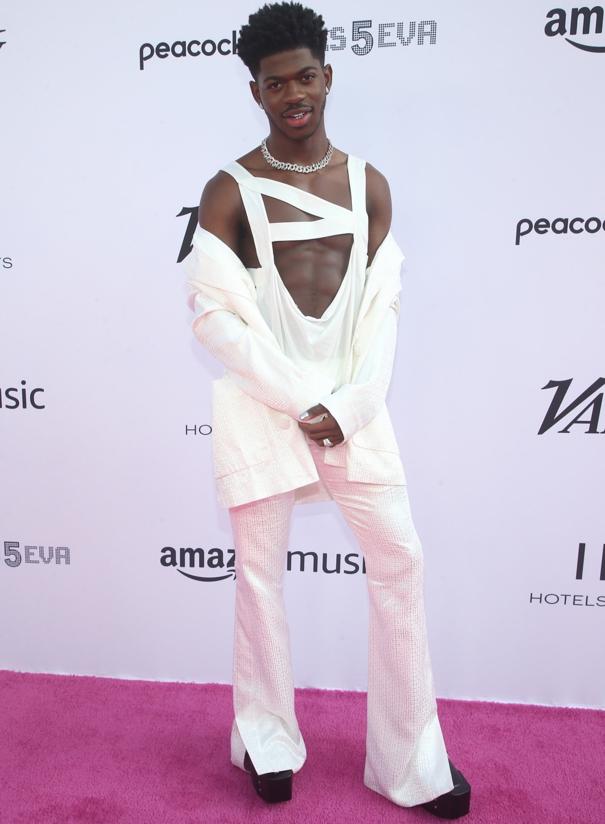 Lil Nas X turns heads in a daring cutout ensemble and towering platform boots, adding dramatic flair and a stylish boost to his height at the 2021 Variety Hitmakers event
