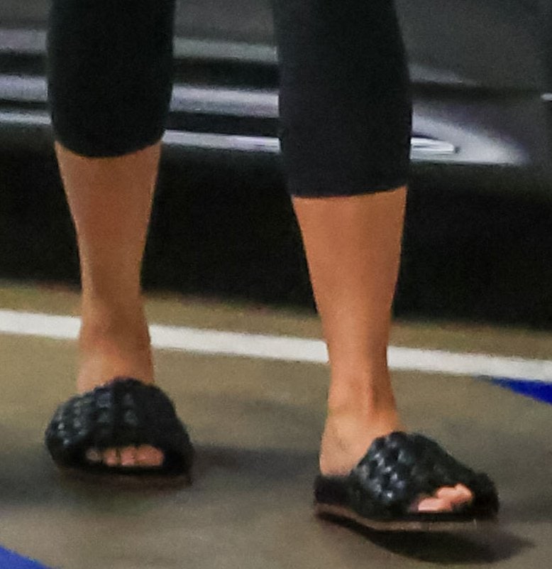 Chrissy Teigen steps out in Chloé Kacey woven leather slide sandals, pairing the relaxed silhouette with cropped leggings for an effortless off-duty look