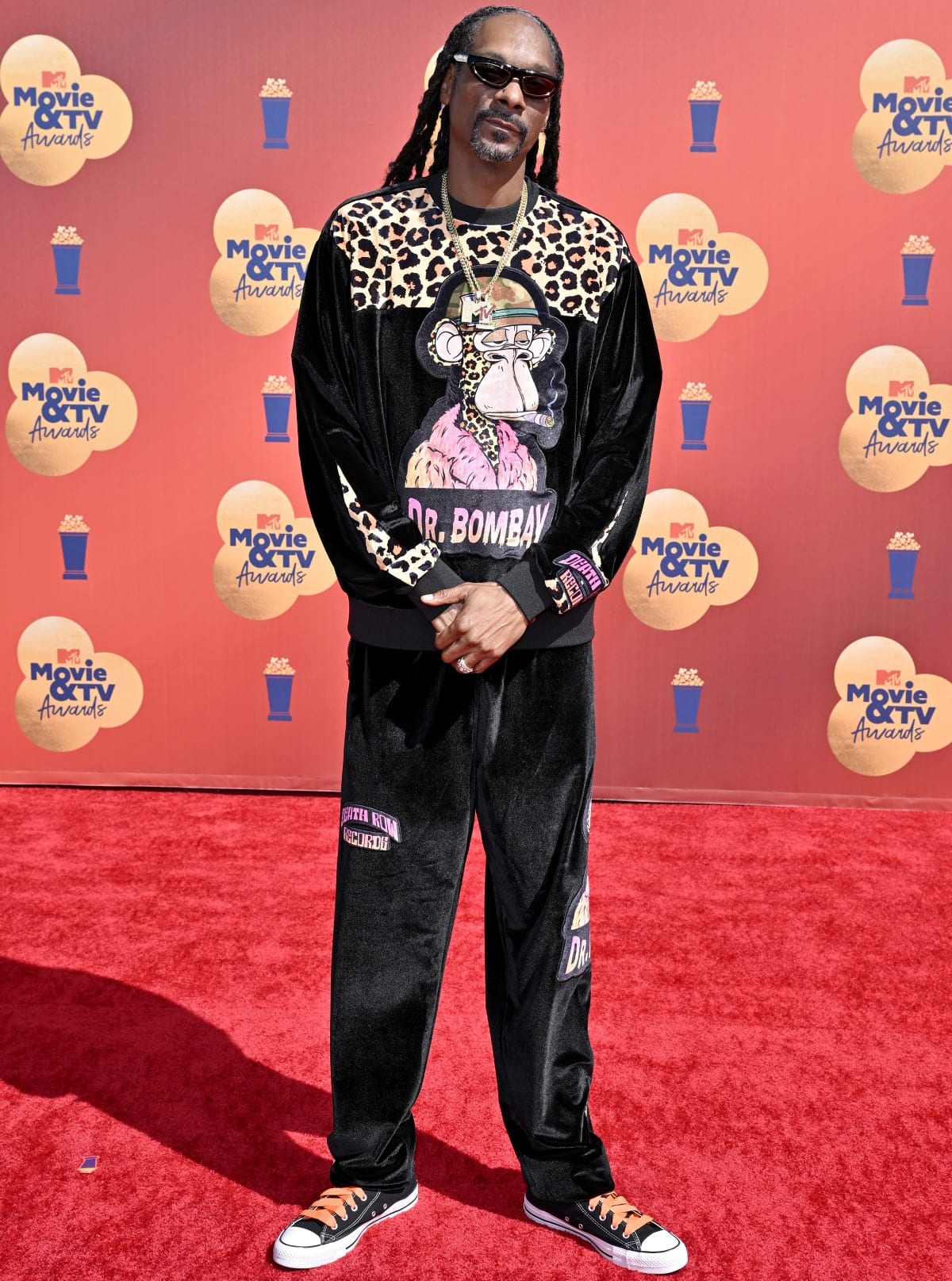 Snoop Dogg brings West Coast flair in his custom Dr. Bombay tracksuit and classic black Converse Chuck Taylors at the 2022 MTV Movie TV Awards on June 5, 2022