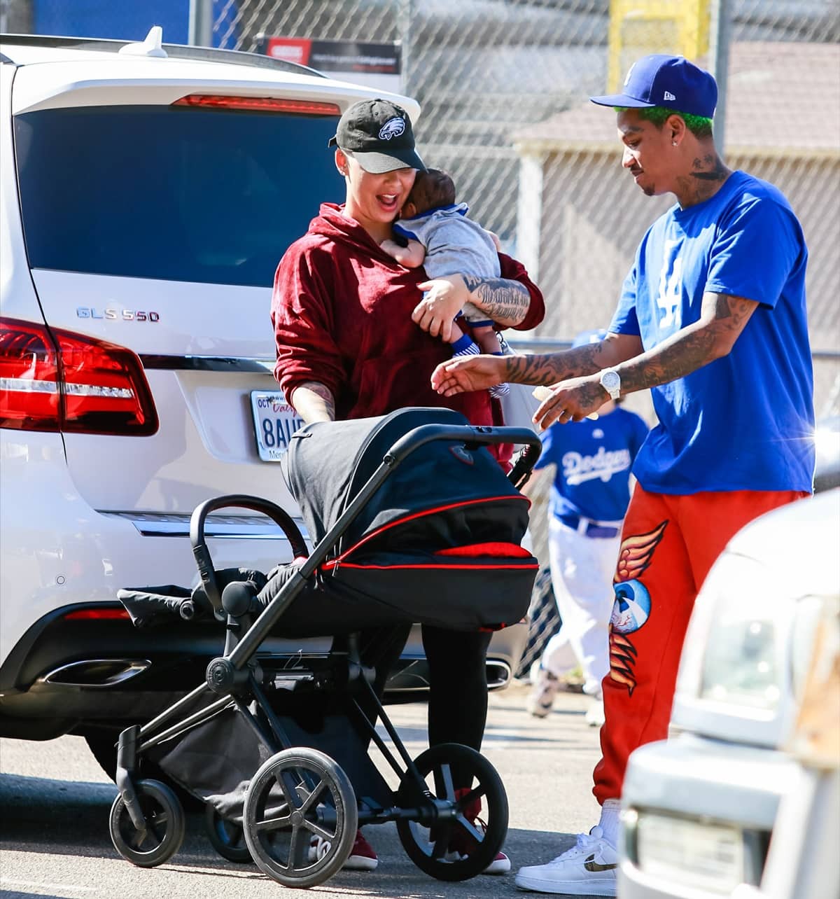 Amber Rose kept things casual in a burgundy velvet hoodie, black leggings, and red low-top sneakers while spending time with Alexander Edwards and her son Sebastian Taylor Thomaz in Los Angeles on November 10, 2019