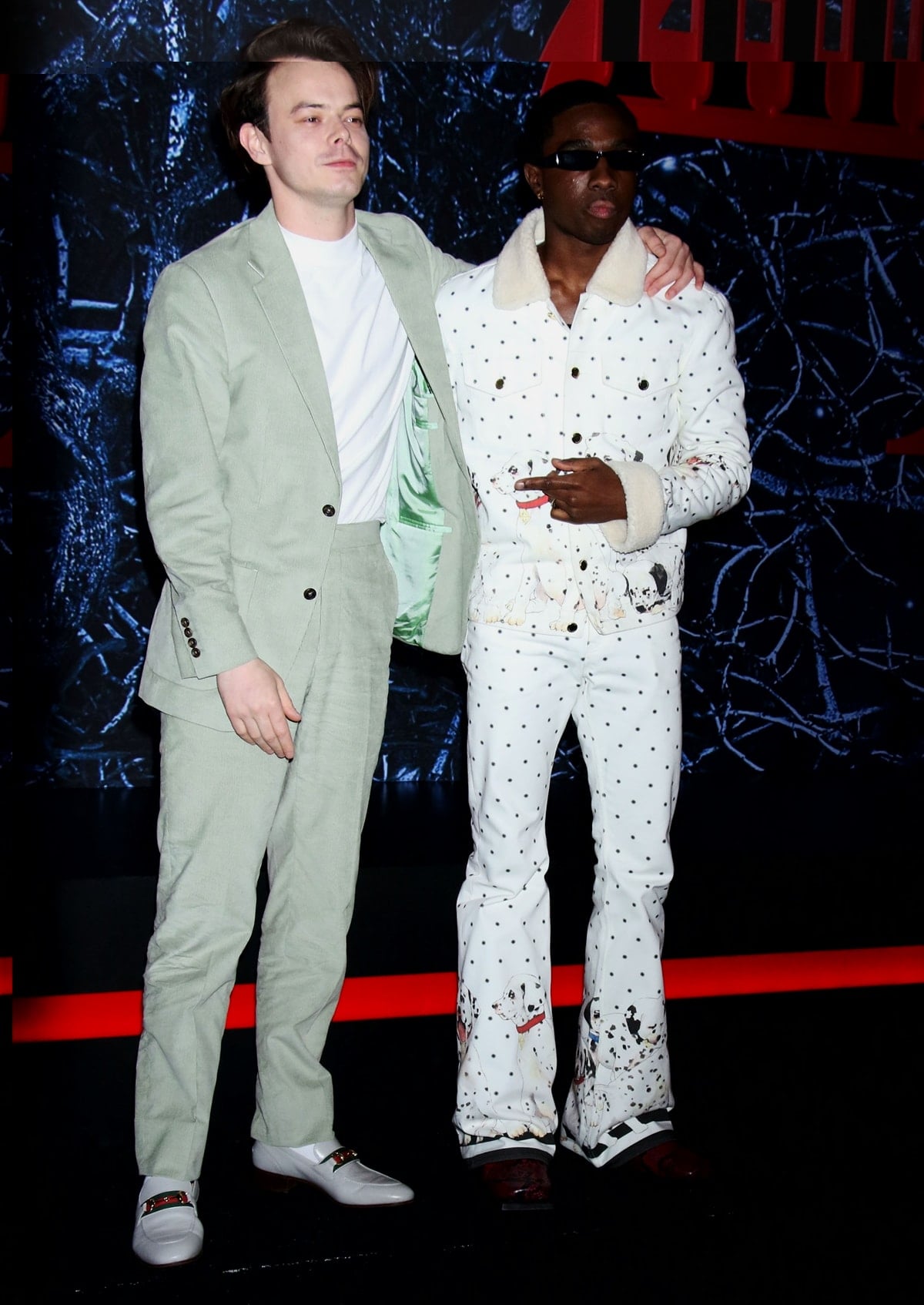 Charlie Heaton kept it classic in a sage green suit paired with white Gucci loafers, while Caleb McLaughlin turned heads in a playful polka-dot Casablanca ensemble featuring Dalmatian prints and furry trim at the Stranger Things Season 4 premiere in Brooklyn on May 14, 2022