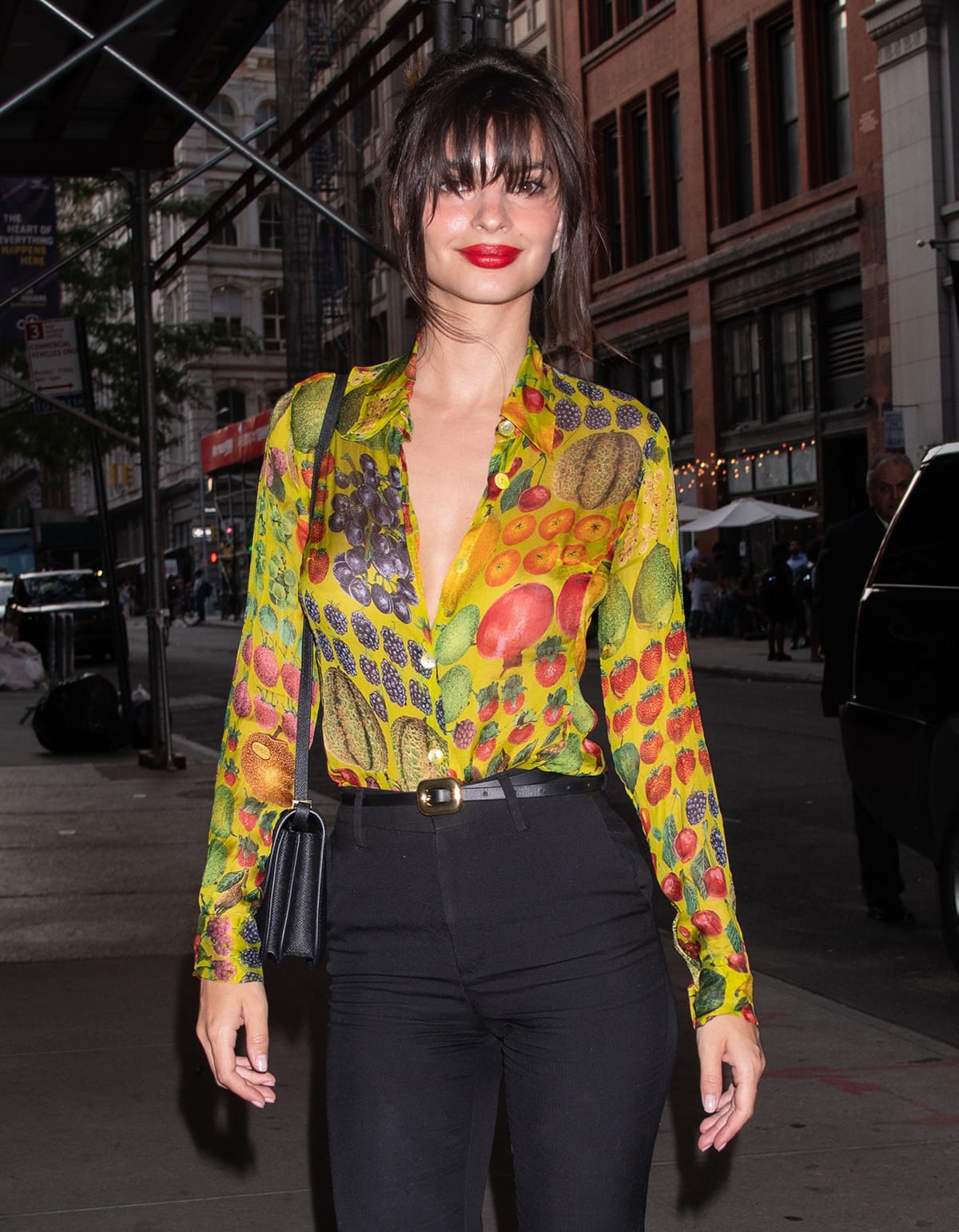 Emily Ratajkowski looks hot with red lipstick and a messy bun with wispy bangs