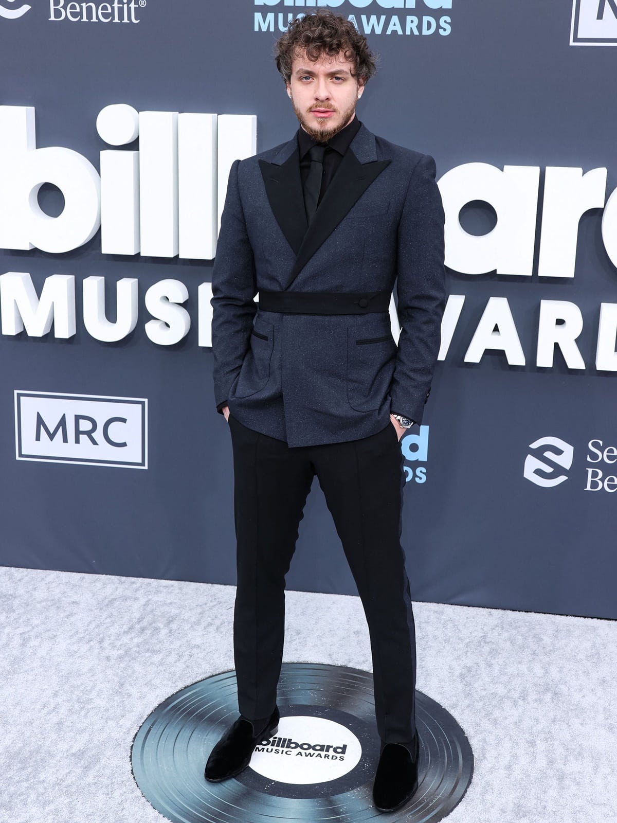 Jack Harlow wearing a sharp all-black Musika suit with a black button-down shirt, tie, and black suede shoes at the 2022 Billboard Music Awards held at the MGM Grand Garden Arena in Las Vegas, Nevada, on May 15, 2022
