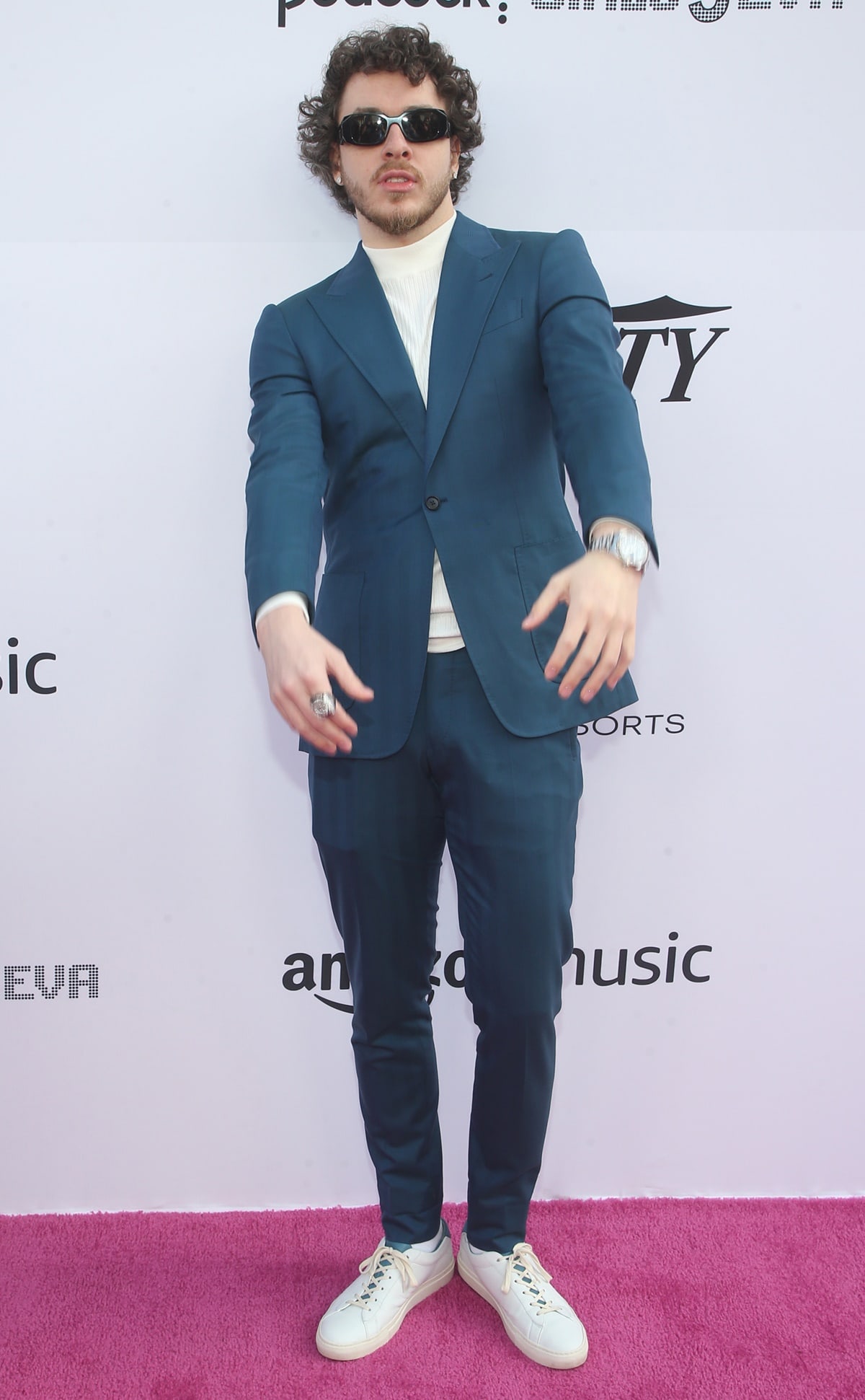 Jack Harlow pairing crisp white sneakers with a dark tailored suit and ribbed turtleneck at Variety’s Hitmakers Brunch presented by Peacock | Girls5eva in Downtown Los Angeles on December 4, 2021