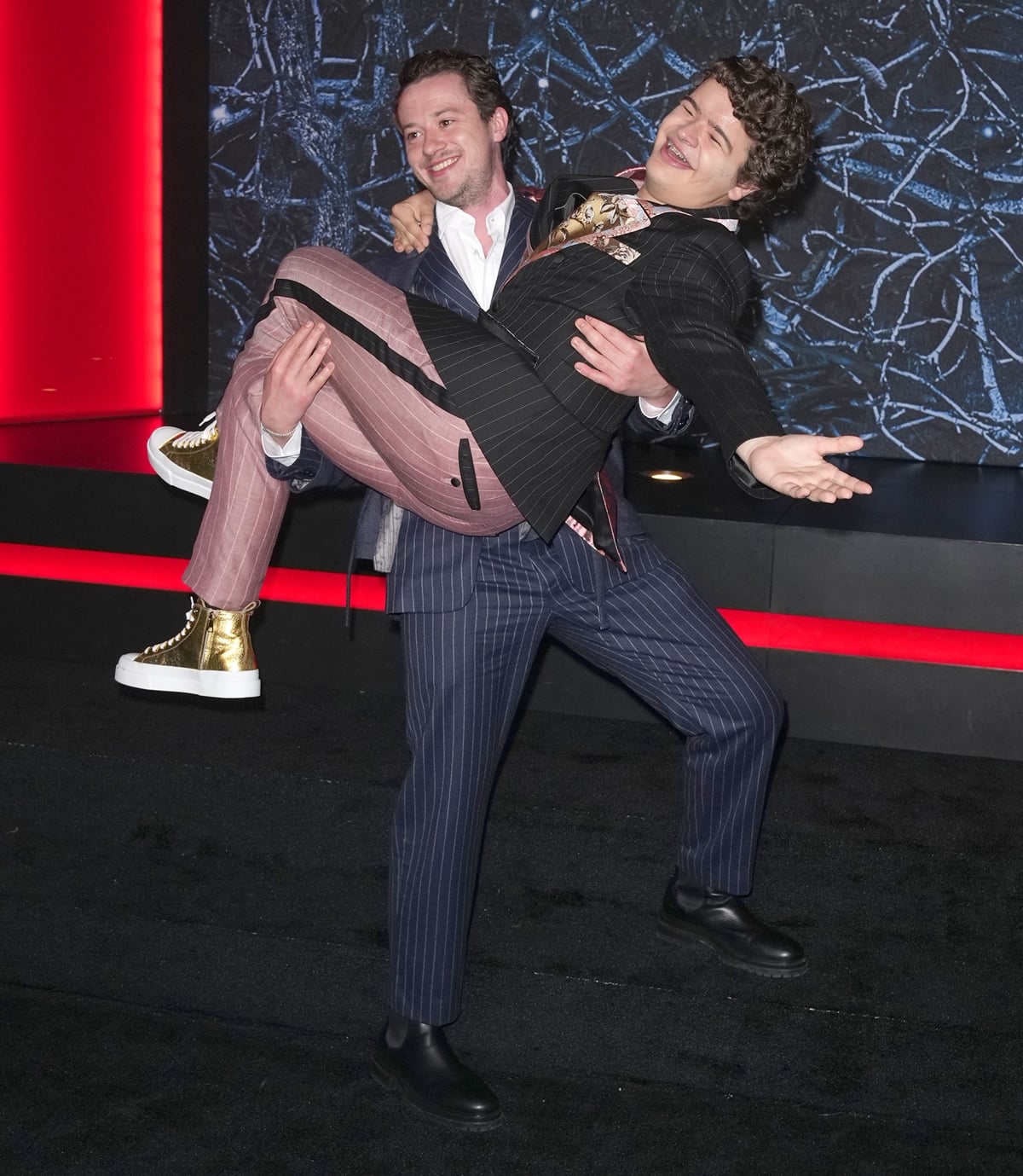 Joseph Quinn carries his much shorter co-star Gaten Matarazzo at Netflix's "Stranger Things" Season 4 Premiere