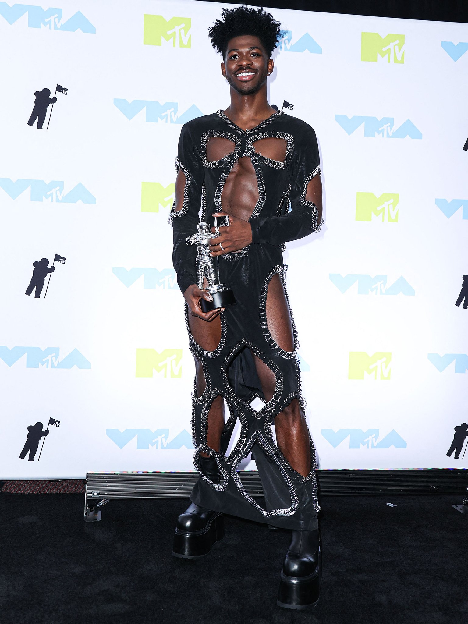 Lil Nas X picks up three Moon Person trophies in a custom Marko Monroe cutout dress with silver rings