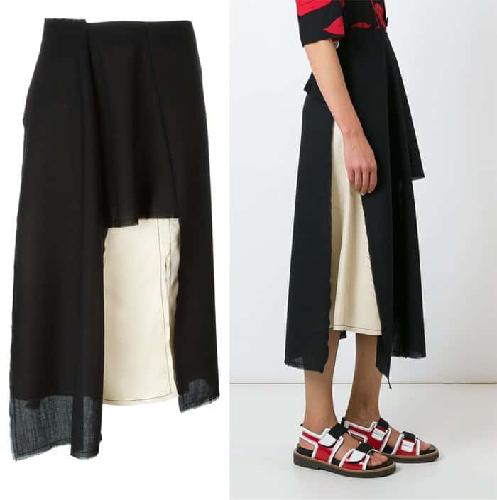 The Marni asymmetric skirt combines a sheer black overlay with a structured ivory underlayer, creating depth and movement that defines the outfit’s modern proportions