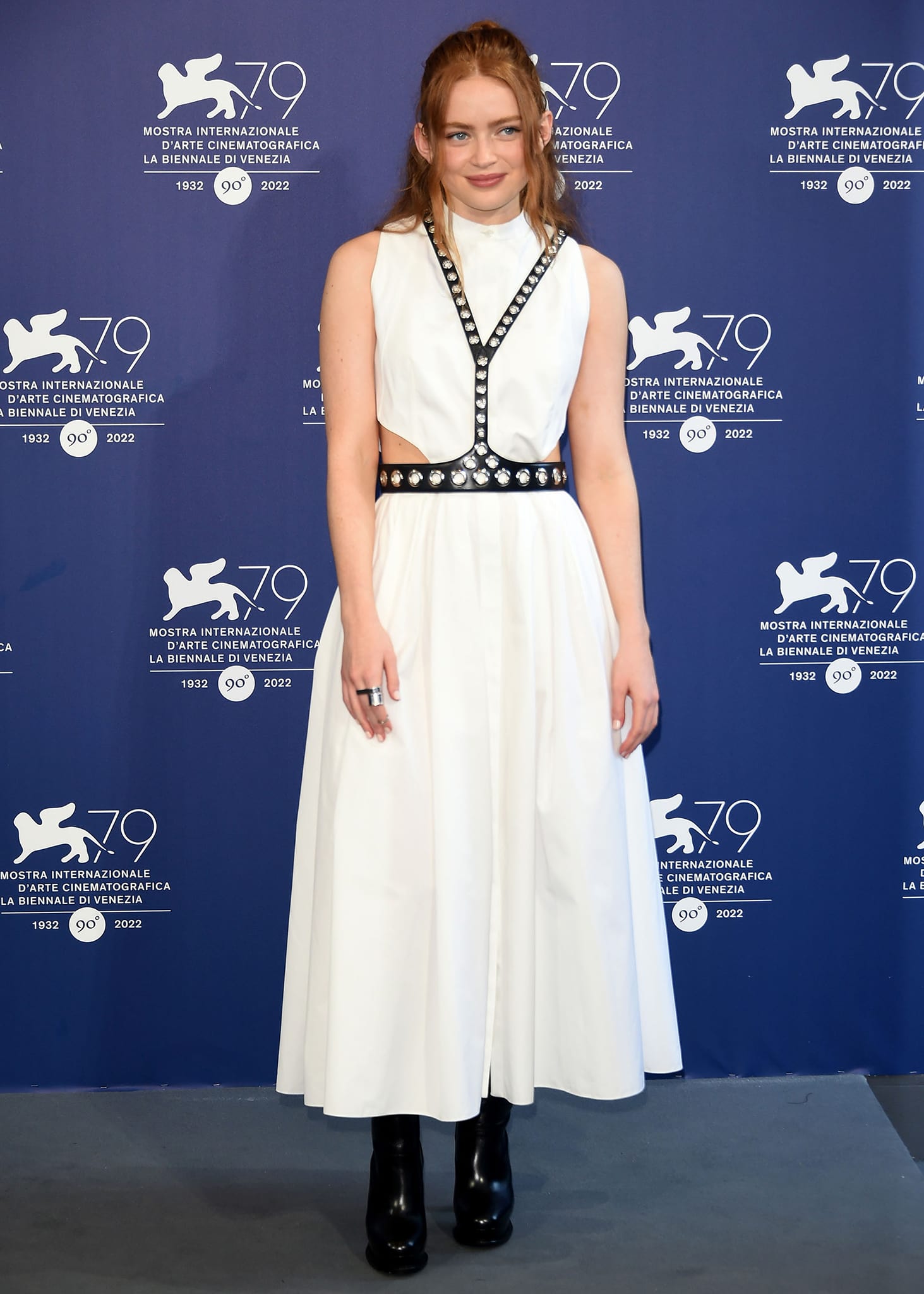 Sadie Sink attends The Whale photocall in an Alexander McQueen cotton poplin midi dress layered with a grommet-embellished leather harness