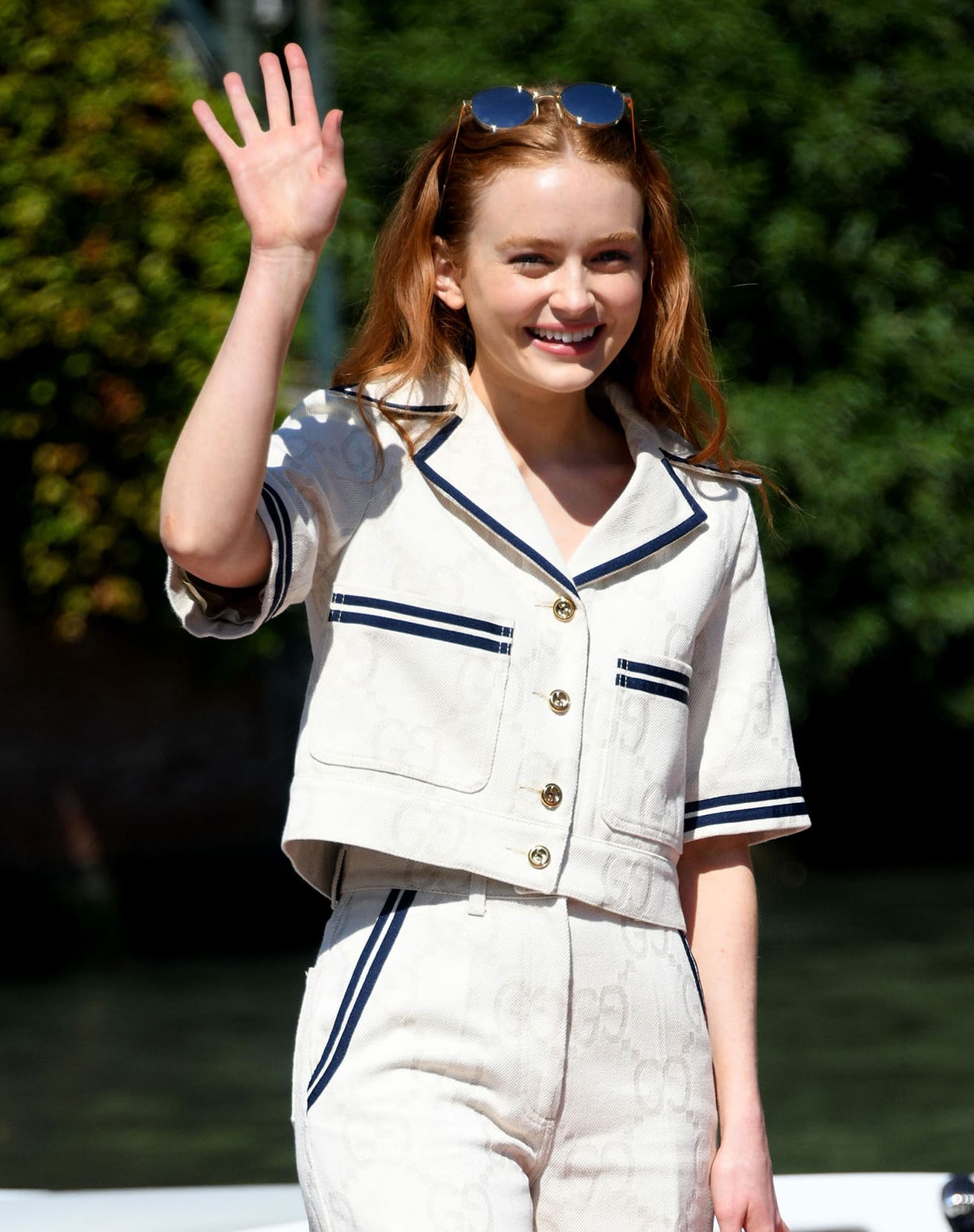 Sadie Sink flashes her pearly whites and wears her Gucci round sunnies on top of her head