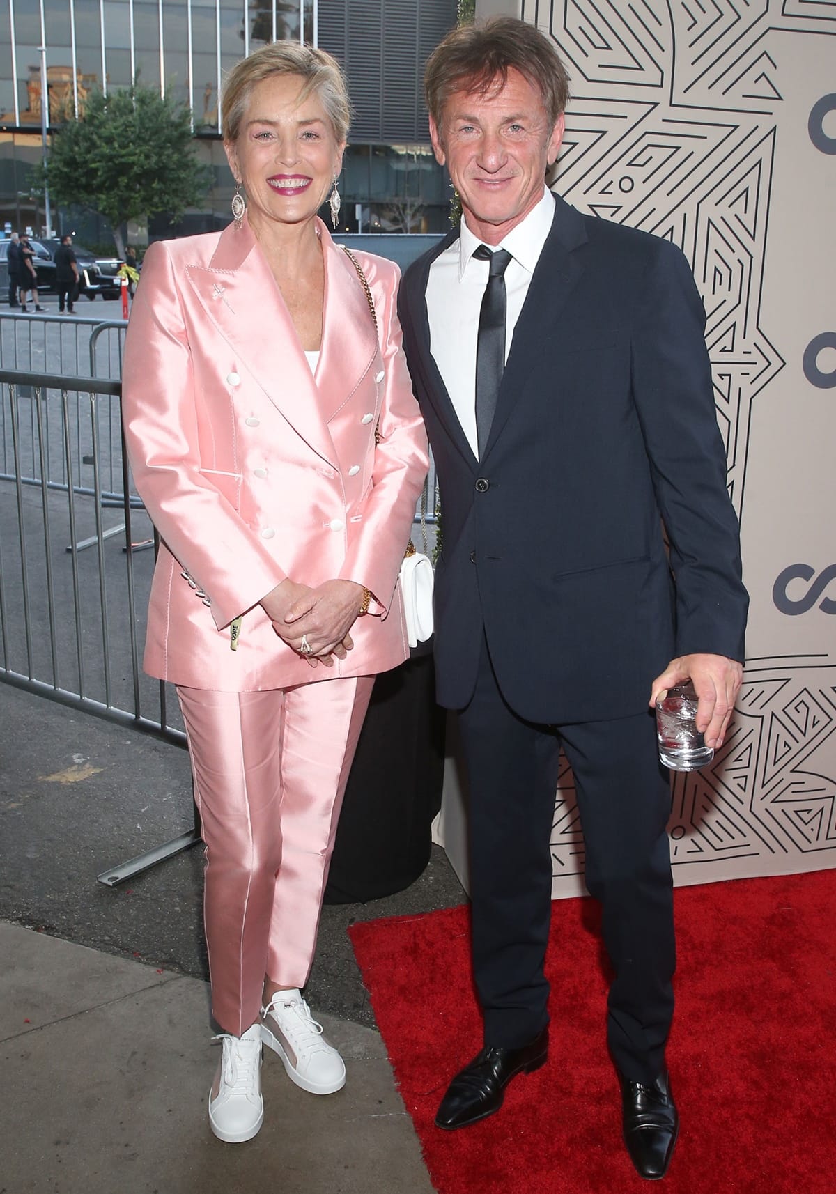 Sharon Stone, wearing a pink satin pantsuit and Dolce Gabbana sneakers, joined Sean Penn at the 2022 CORE Gala