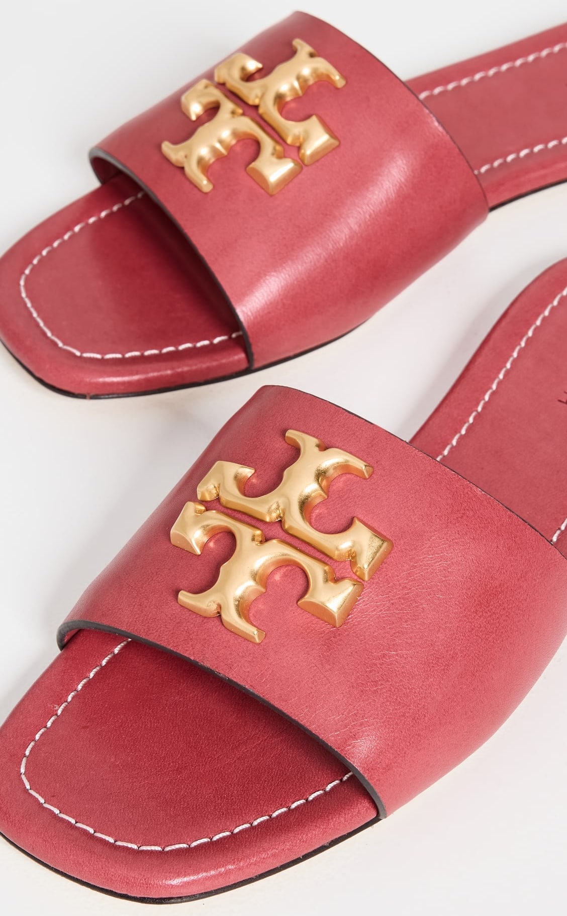 Crafted in smooth leather with Tory Burch’s signature double-T hardware, these slides highlight the brand’s focus on clean stitching and refined, attainable-luxury design