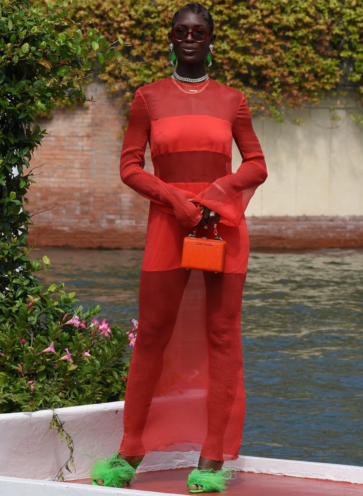 Jodie Turner-Smith shows how to wear an Interior Spring 2022 red dress with green feather heels