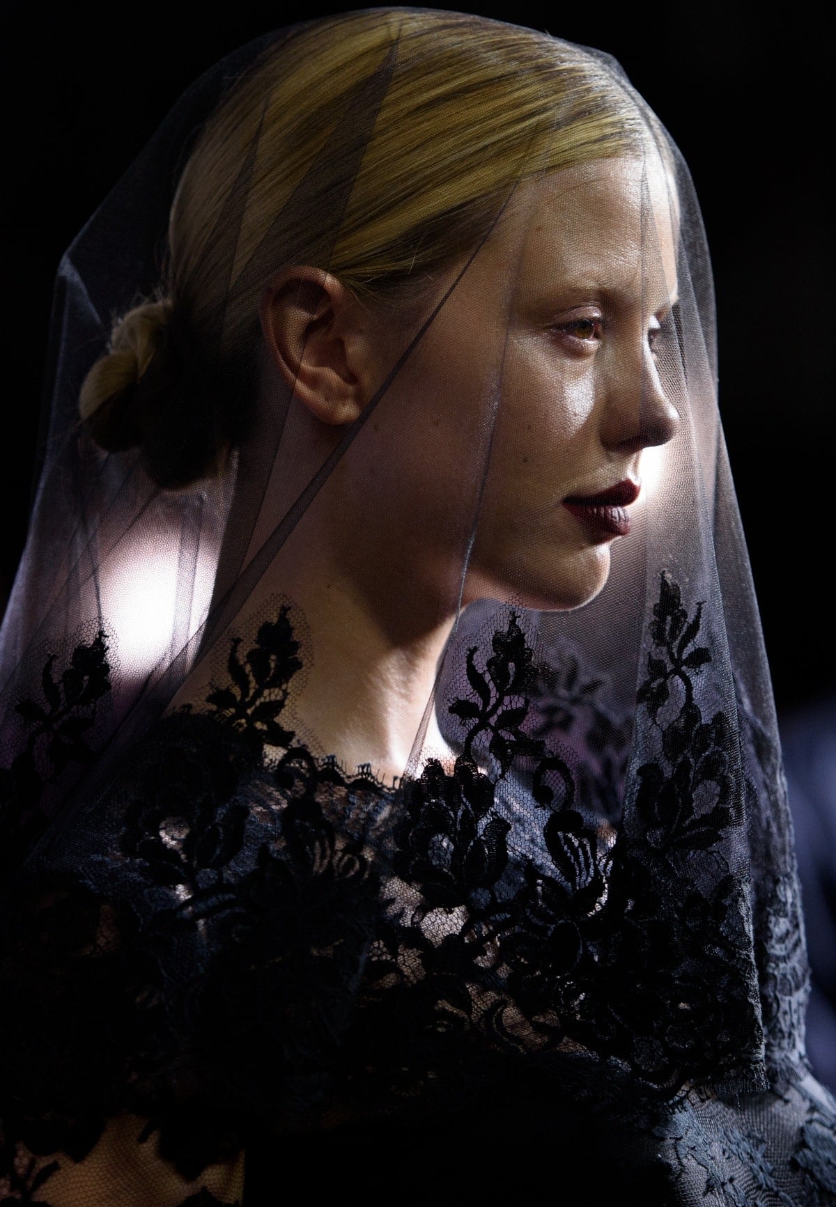 Mia Goth’s gothic-lace veil and deep berry lip create a hauntingly elegant finish to her Dolce Gabbana Alta Moda look at the Pearl premiere during the 47th Toronto International Film Festival