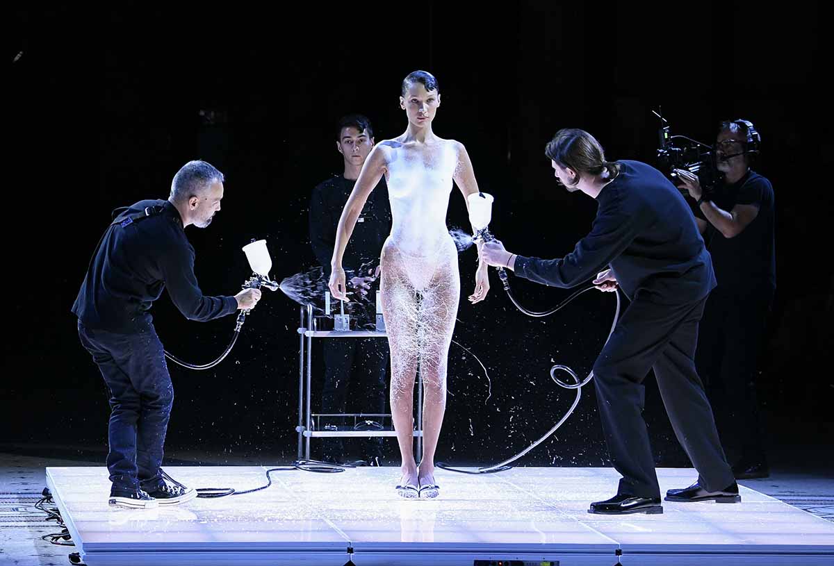 Dr. Manel Torres and two technicians apply the Fabrican spray onto Bella's naked body