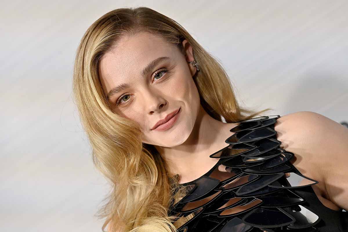 Chloë Grace Moretz wears light pink makeup and styles her tresses in side-parted waves