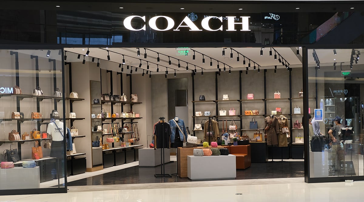 A Coach boutique display highlights the brand’s enduring popularity in American fashion, though most of its handbags are now produced overseas in countries such as Vietnam, Cambodia, and the Philippines