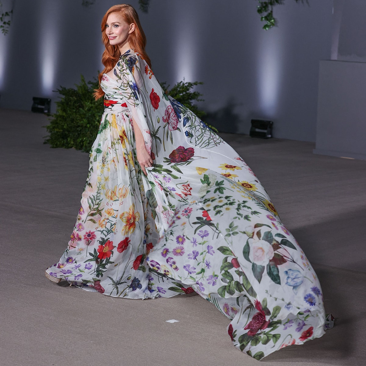 Jessica Chastain looks every inch the Hollywood star in an airy white chiffon cape gown with colorful botanical prints