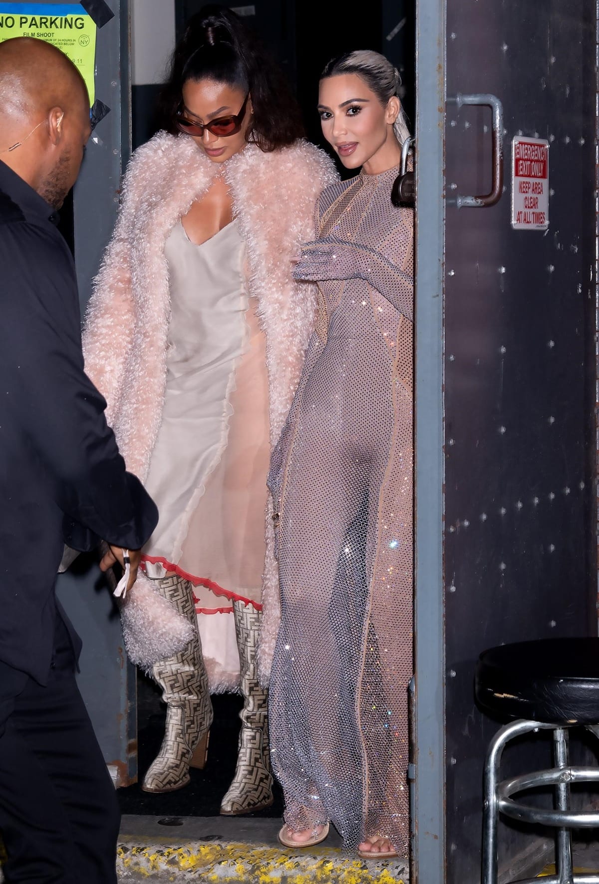 Kim Kardashian stuns in a sheer sparkling catsuit with nude sandals, while LaLa Anthony pairs Fendi logo boots with a plush pink coat as they head to the Fendi after party on September 9, 2022, in New York City