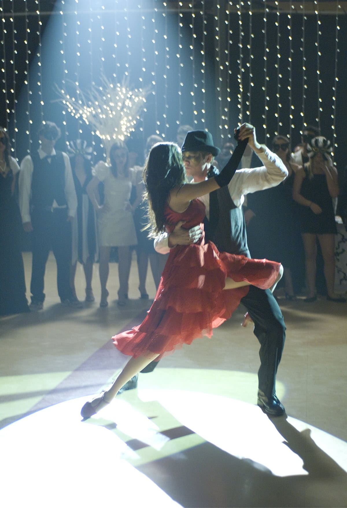 Selena Gomez dazzles in a tiered scarlet tango dress paired with satin character heels during the film’s climactic “Black and White Ball” dance, a modern spin on Cinderella’s royal moment opposite Drew Seeley