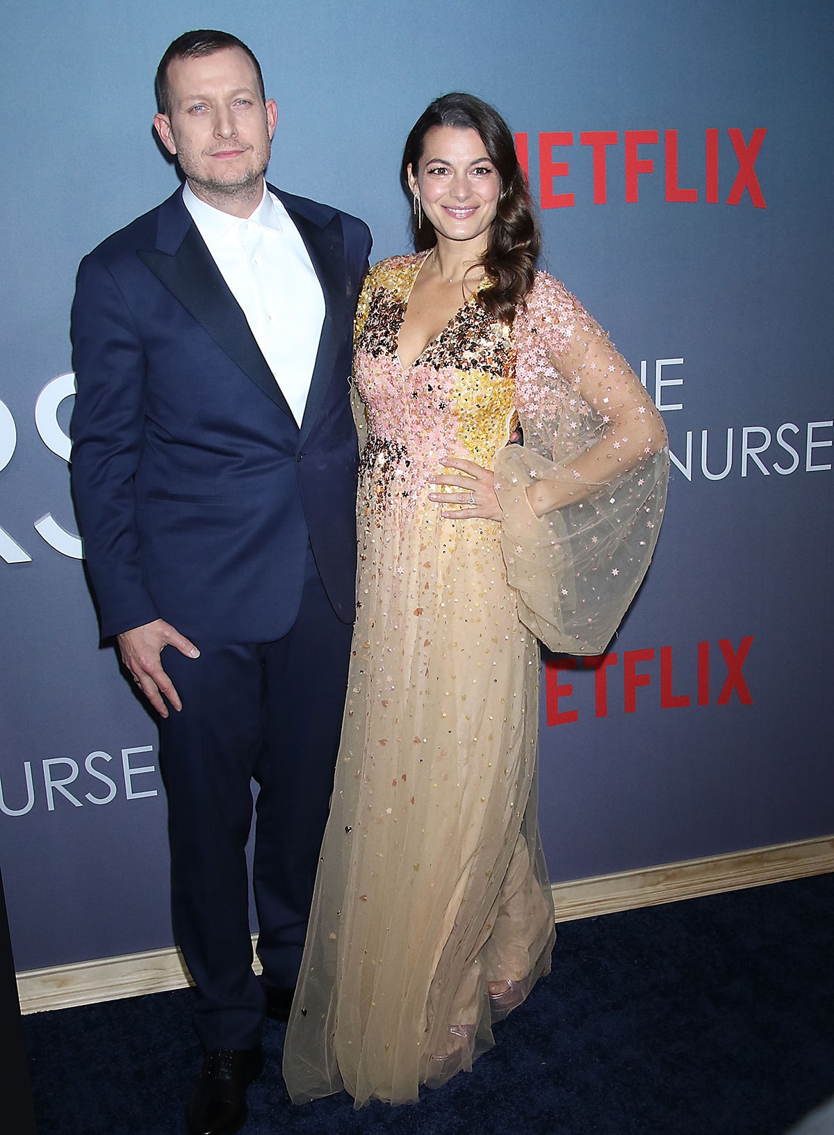 Tobias Lindholm and Caroline Blanco attend the New York screening of The Good Nurse, with Blanco shimmering in a delicate, embellished sheer gown paired with understated neutral heels