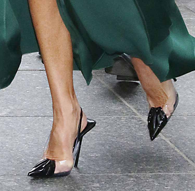 Victoria Beckham wears black Saint Laurent Chica leather and PVC slingback pumps