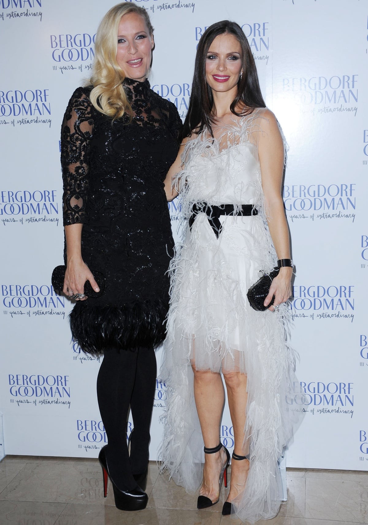 Georgina Chapman and Keren Craig celebrate their Marchesa brand at Bergdorf Goodman, with Chapman turning heads in feather-embellished white tulle and black ankle-strap Christian Louboutin heels