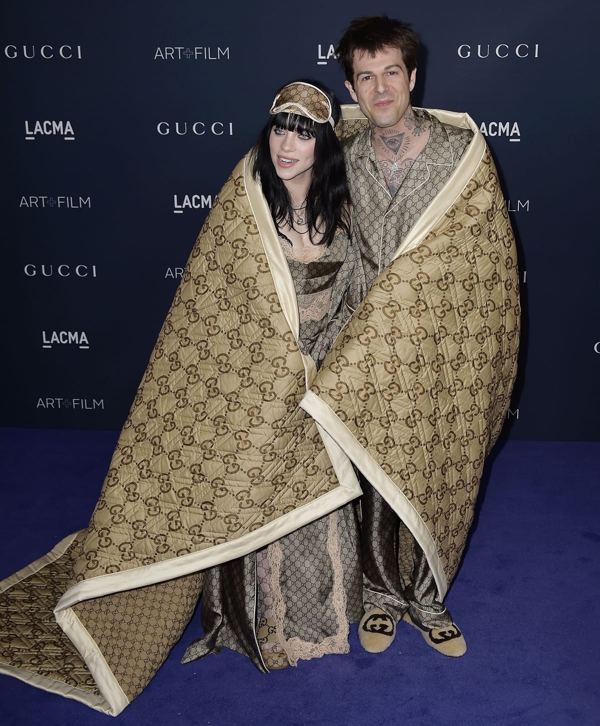 Billie Eilish and her boyfriend Jesse Rutherford in matching silk pajamas and a large Gucci blanket at the 11th Annual LACMA Art + Film Gala