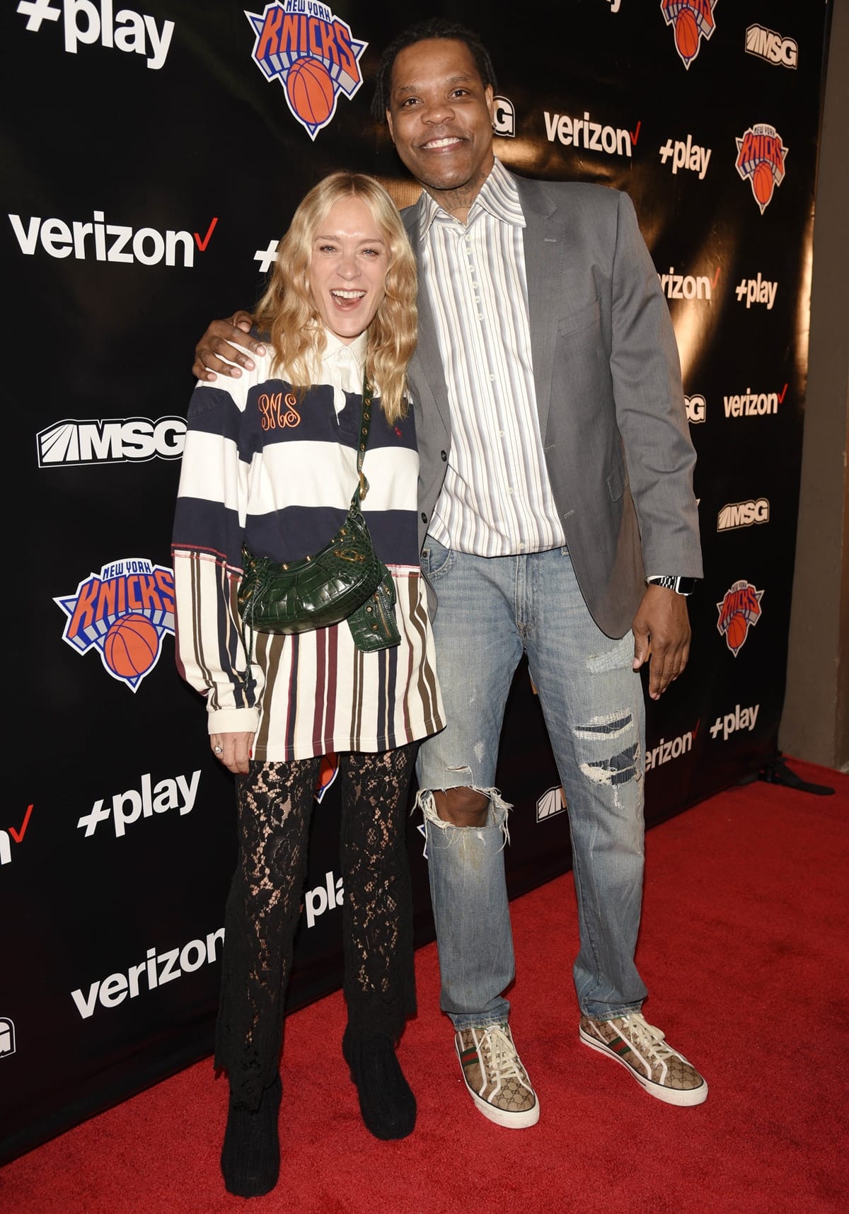 Chloë Sevigny and former Knicks player Latrell Sprewell attend the Verizon +play Red Carpet at Madison Square Garden for the New York Knicks home opener on October 21, 2022, in New York City, with Latrell towering over Chloe in their stylish looks