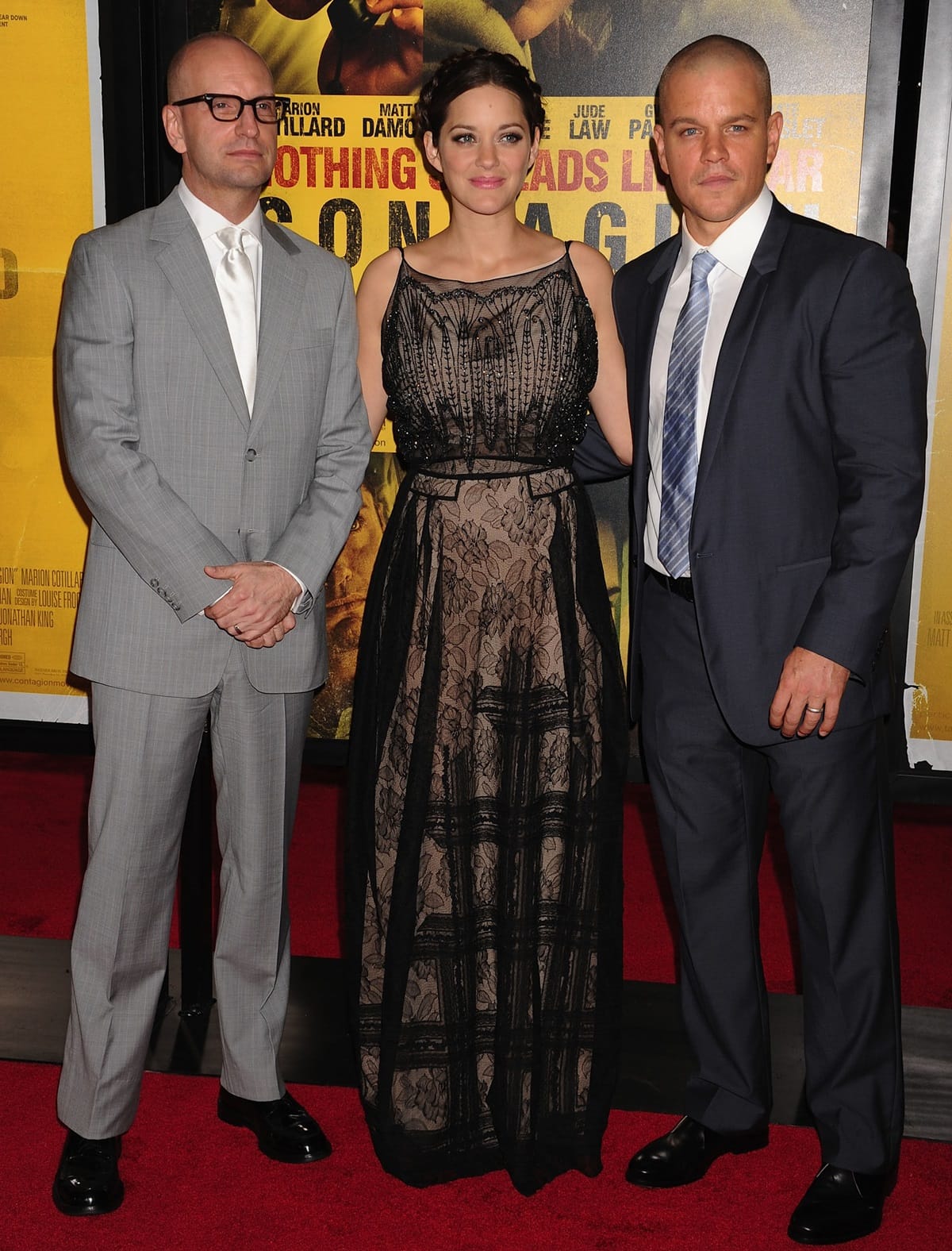 Director Steven Soderbergh, actress Marion Cotillard in a dress and shoes by Christian Dior, and actor Matt Damon in a Calvin Klein Collection suit at the "Contagion" premiere