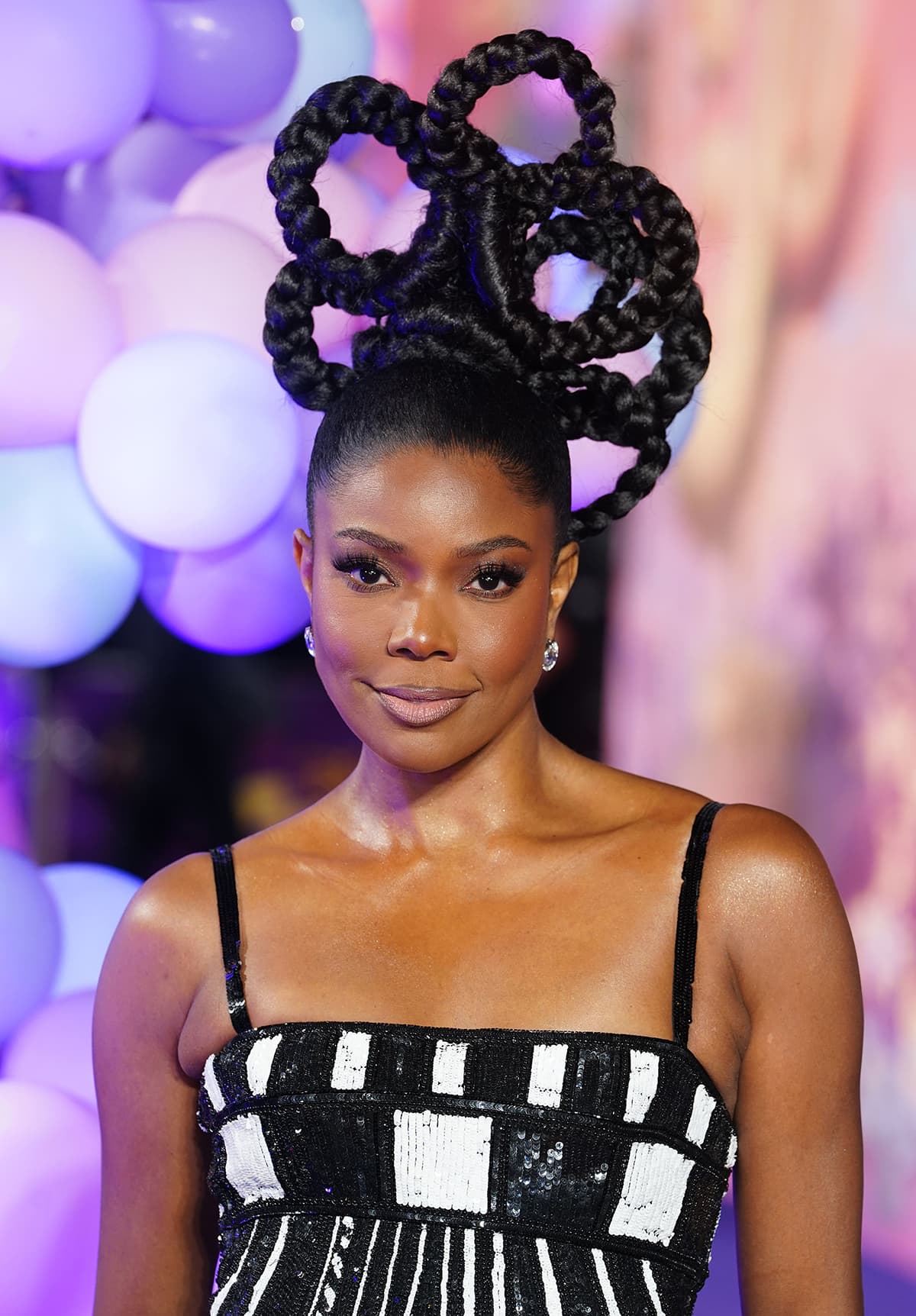 Gabrielle Union commands attention with a sculptural braided updo shaped into dramatic flower-like loops