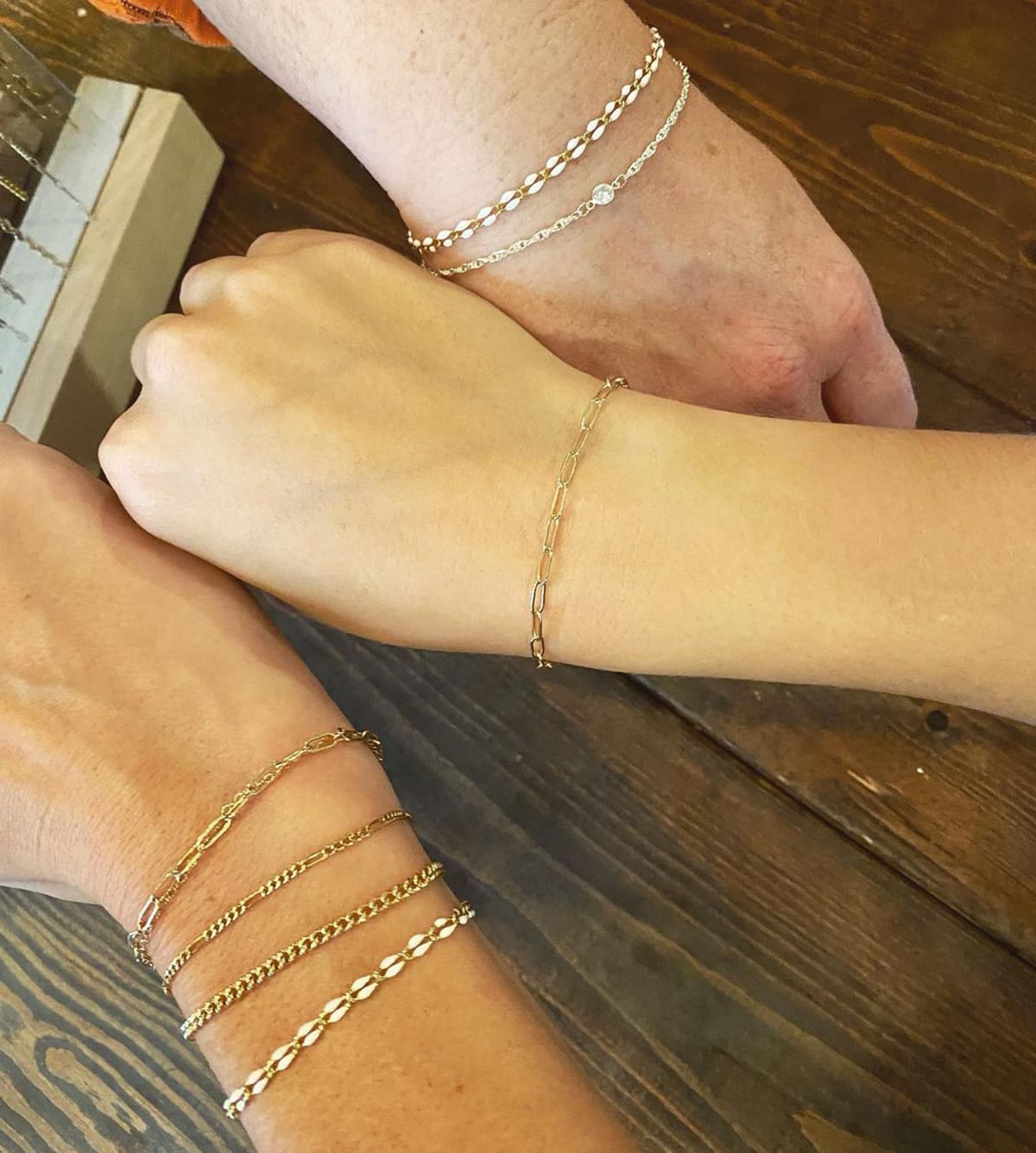 Permanent jewelry bracelets in gold and silver are welded directly onto the wrist, symbolizing enduring connection and effortless everyday style