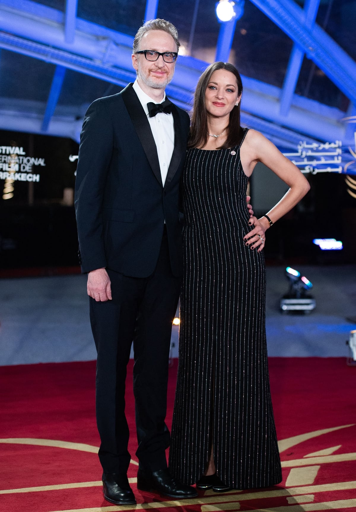 James Gray and Marion Cotillard attend the 19th Marrakech International Film Festival on November 12, 2022, with Cotillard wearing a black Chanel beaded column gown paired with black satin Chanel slingback pumps and Chanel fine jewelry